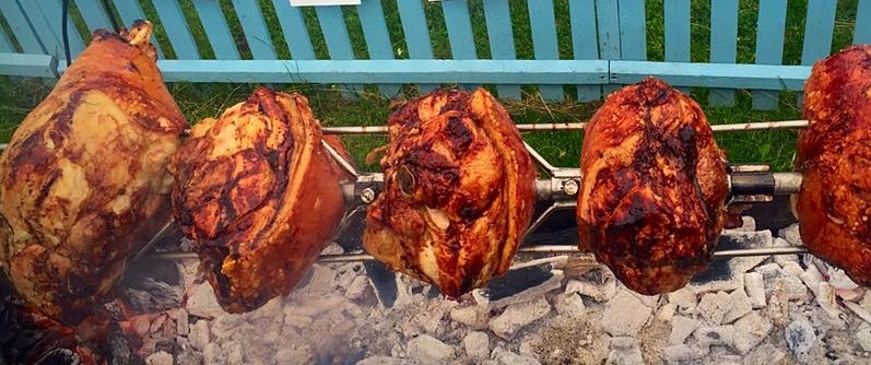 Dingley Dell pork legs cooking over charcoal.jpg