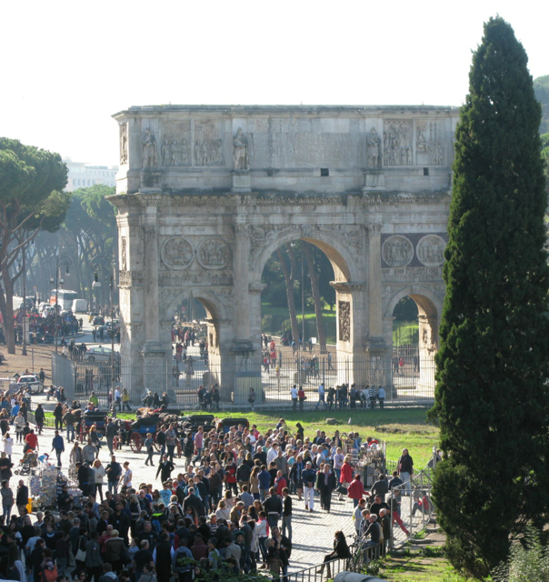 They flock by the thousands to the Colosseum past the Arch of Constantine 