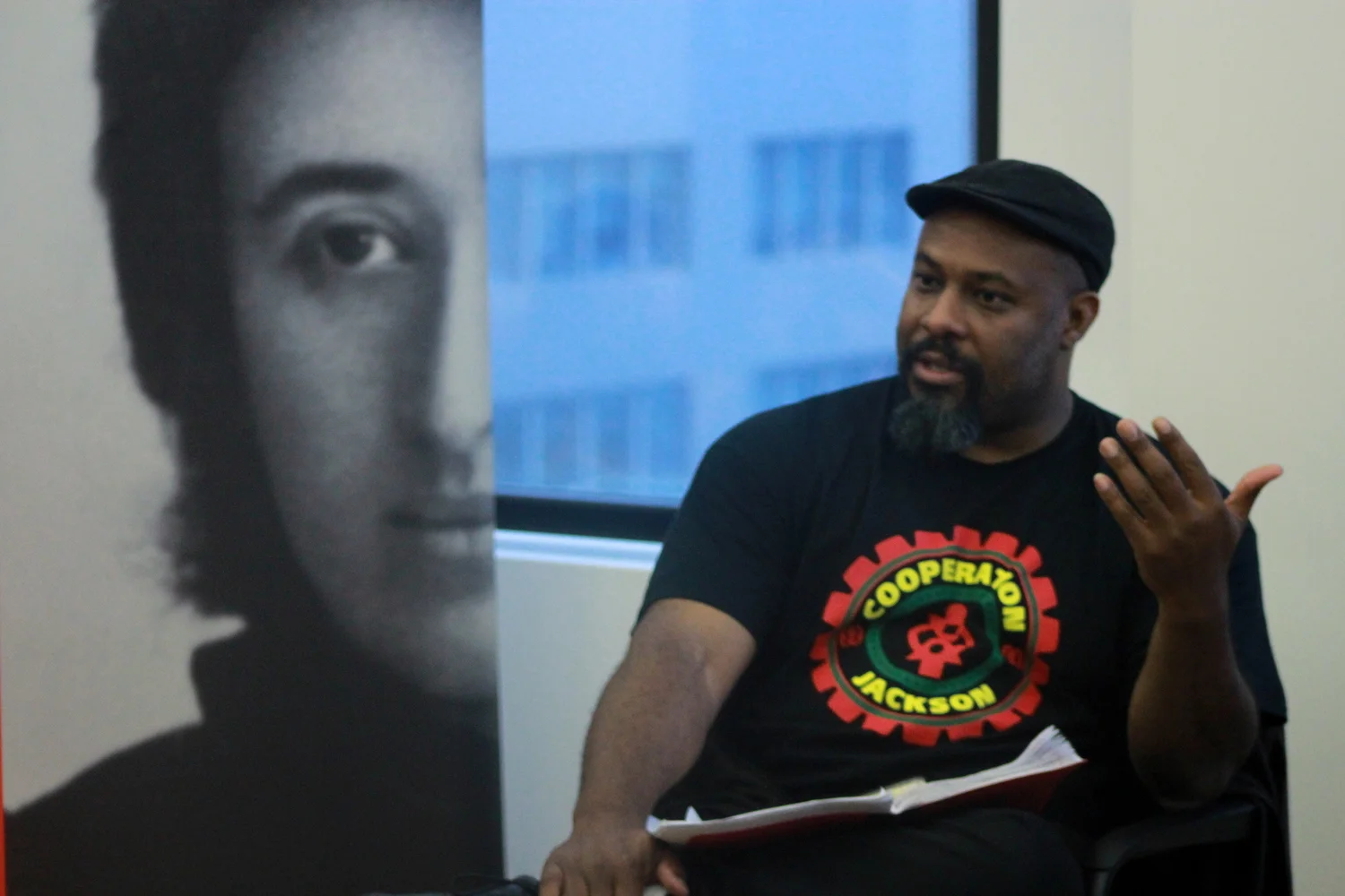 Kali Akuno, who was late Jackson Mayor Chokwe Lumumba’s coordinator of special projects, describing the Jackson Rising conference at the Rosa Luxemburg Foundation office in NYC on June 3. Credit: Rosa Luxemburg-NYC/Flickr