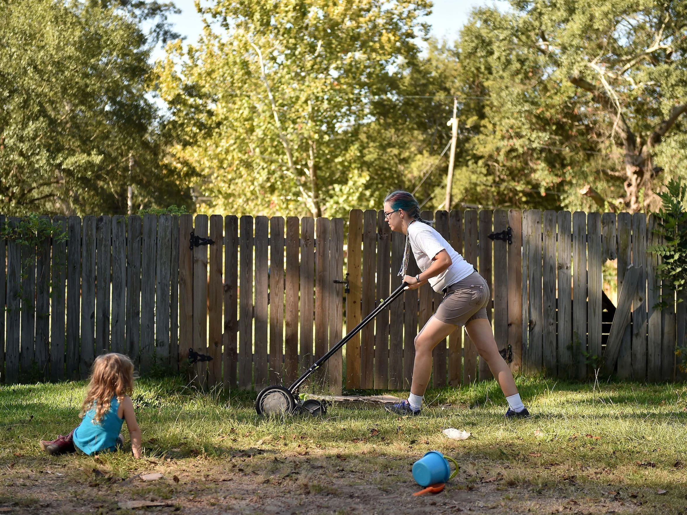 Jackson resident Fasanya Kneice pushes a lawn mower in a garden behind Cooperation Jackson on Oct. 4, 2017, in Jackson. (Photo Credit: Justin Sellers/Clarion Ledger)