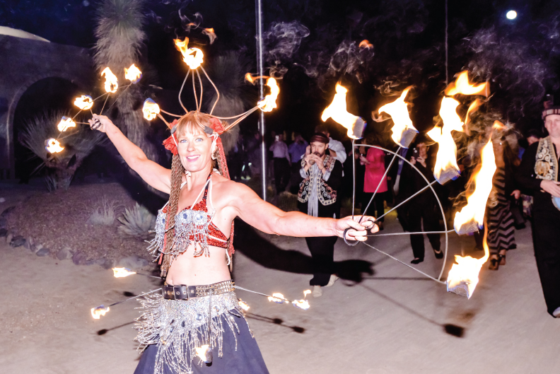 FIRE, WALK WITH ME...... Fire dancer and musicians lead guests from the reception in the citadel to the brand-new ballroom in the grand arena