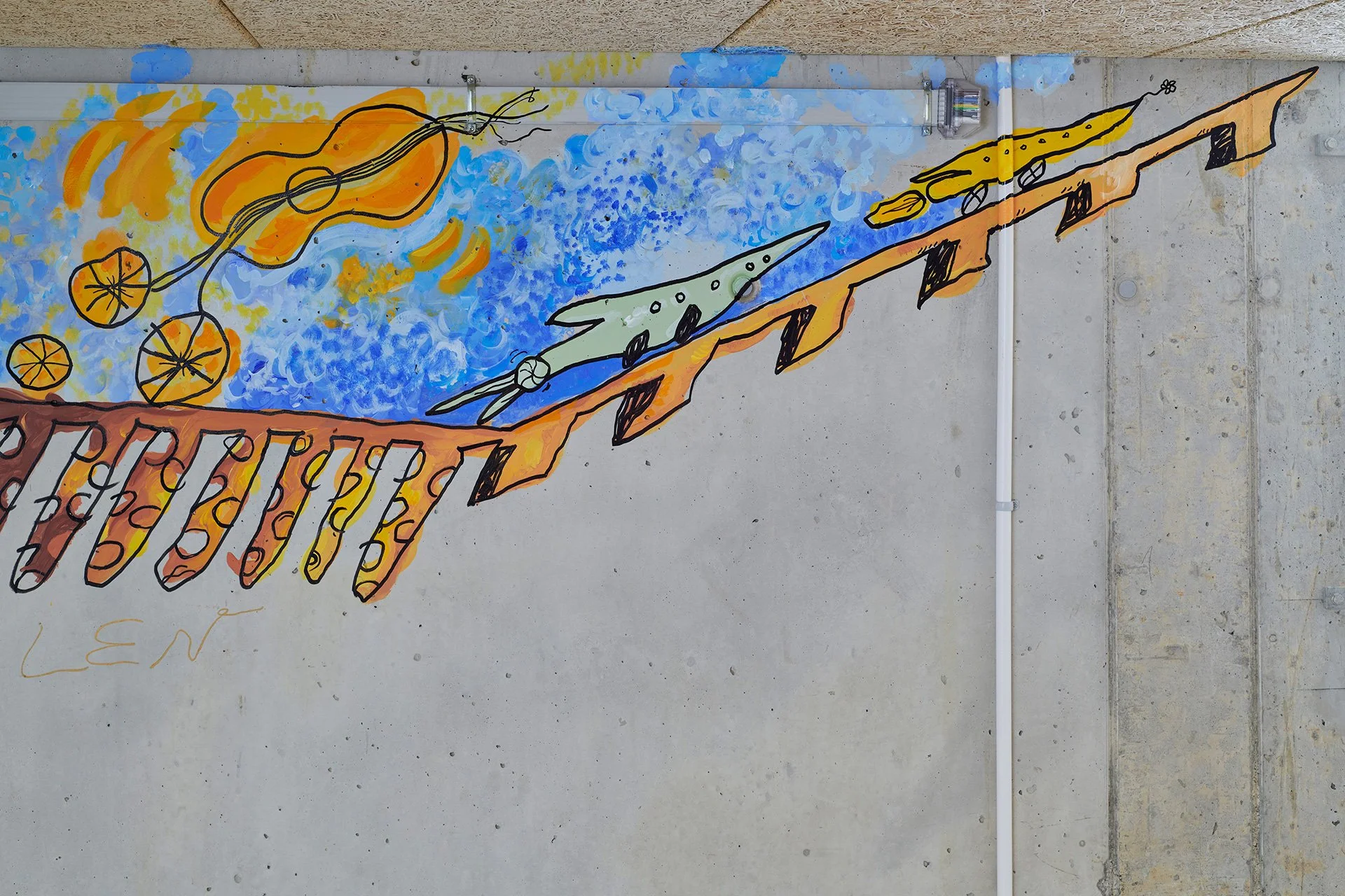 Colorful mural on a concrete wall shows orange planets and a swirling sun above blue space, with stylized spacecraft racing along diagonal tracks; playful, imaginative tone.