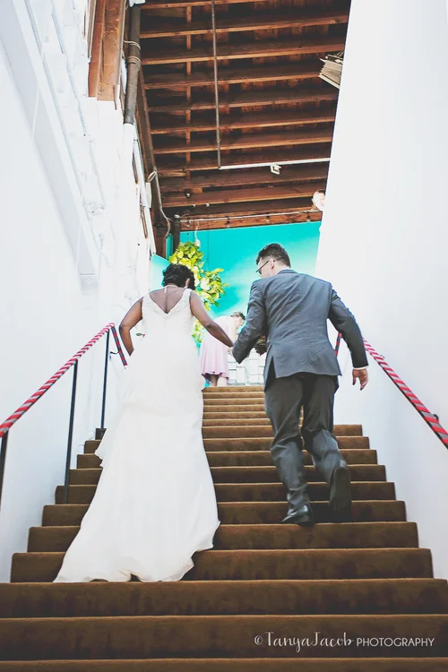 Anita and Mathias hurrying up our stairs as husband and wife to meet their friends and family, many who traveled all the way from India and Germany for the wedding.