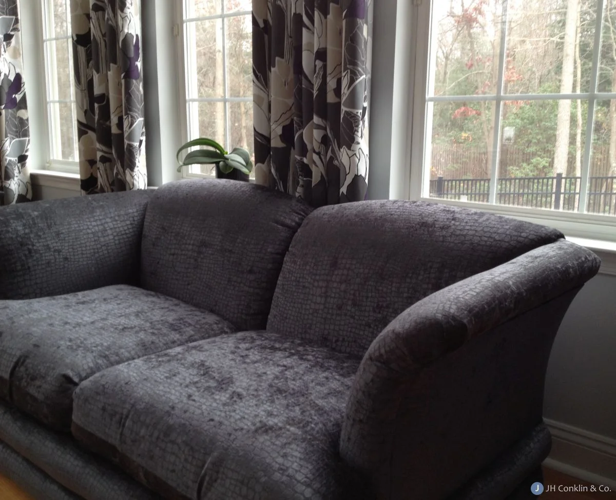 Mullica Hill loveseat re-upholstered in an alligator pattern chenille by Fabricut. The variable nap of the fabric gives a "crushed" look. The shimmery gray color is just right for the room.