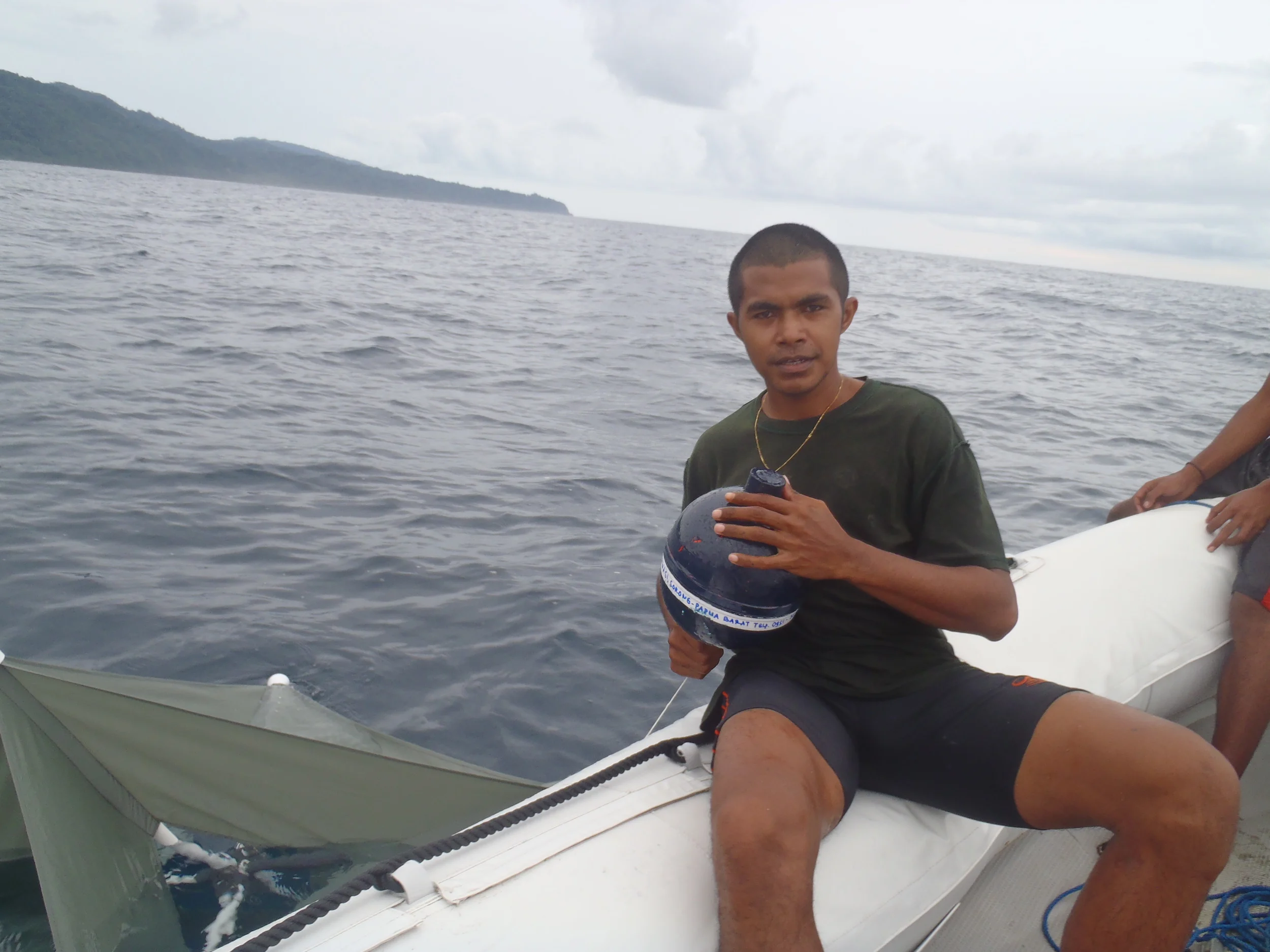   Geoff's field assistant, Oby, ready to deploy a  Microstar  Lagrangian surface drifter to measure the currents off the Bird's Head Peninsula  