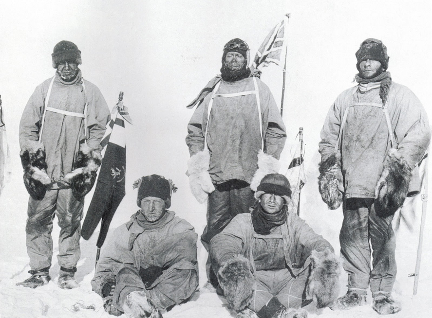 (from left, standing) Oates, Scott and Evans, with (sitting) Bowers and Wilson, display the British flag at the South Pole, a little over a month after Amundsen and his three companions had claimed it for Norway. The film was found at the Last Camp and developed later.