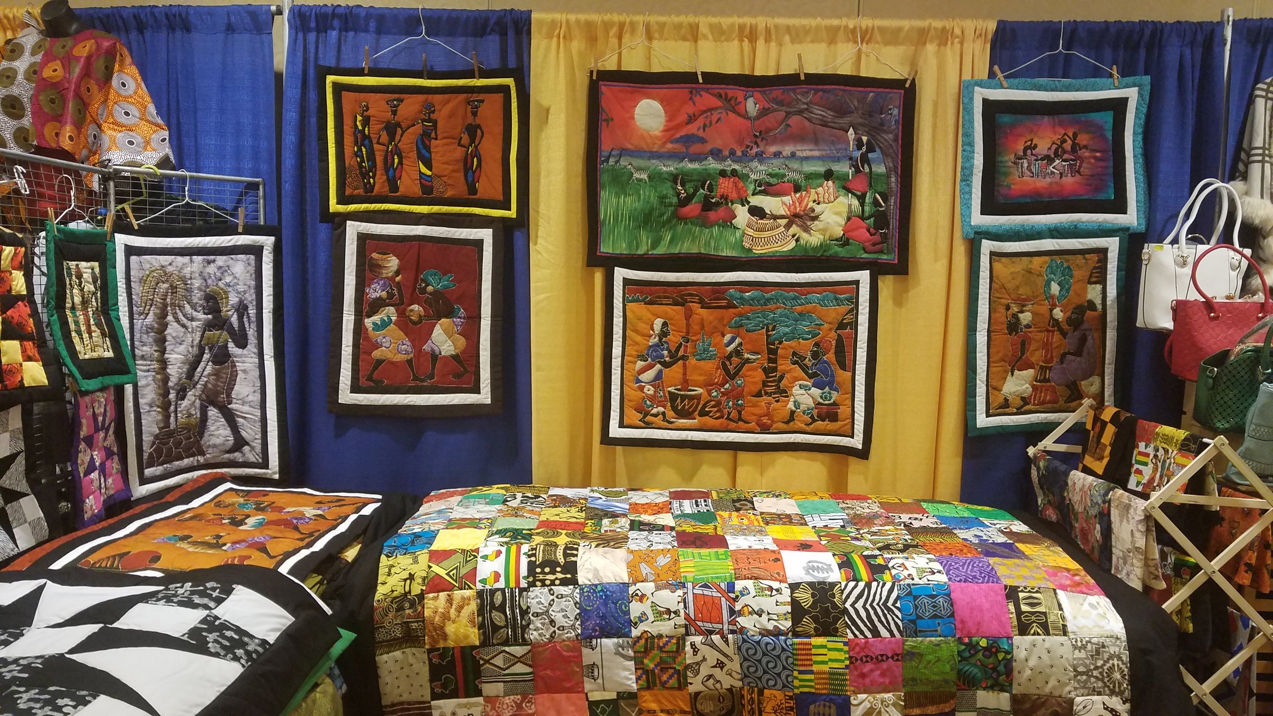 quilt artist Loretta Craig's booth, showing many colorful picture quilts