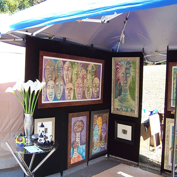 artist Joyce Lomax's booth showing paintings