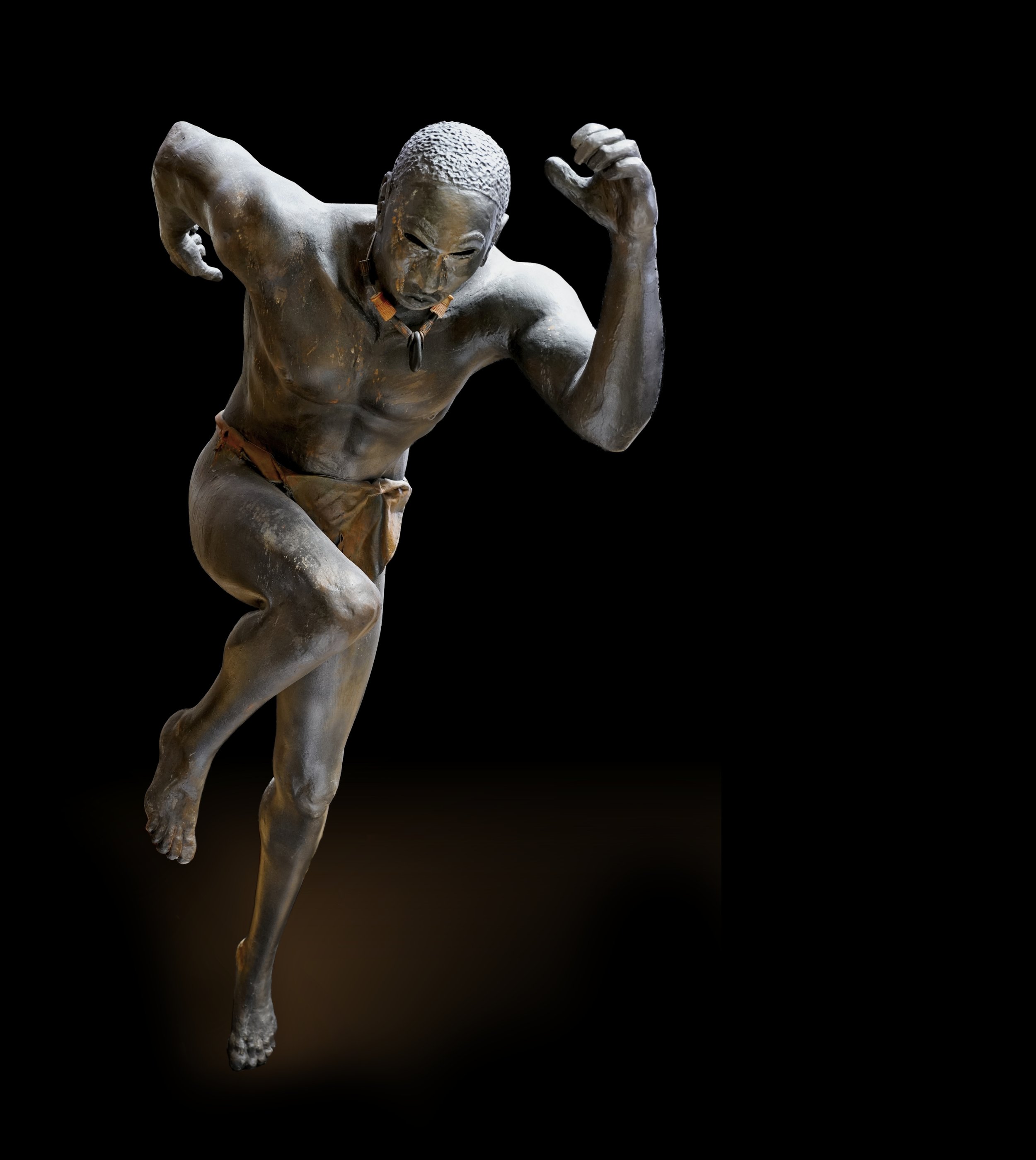 sculpture of African man running, by Aaron Paskins