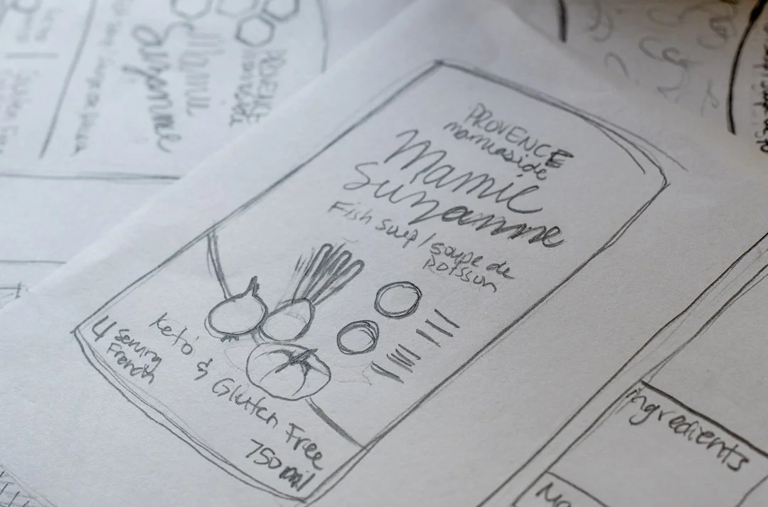 Hand-drawn concept sketch for Mamie Suzanne’s Fish Soup packaging by Laurelle Armet, outlining early design ideas for typography, layout, and illustrated vegetable elements.