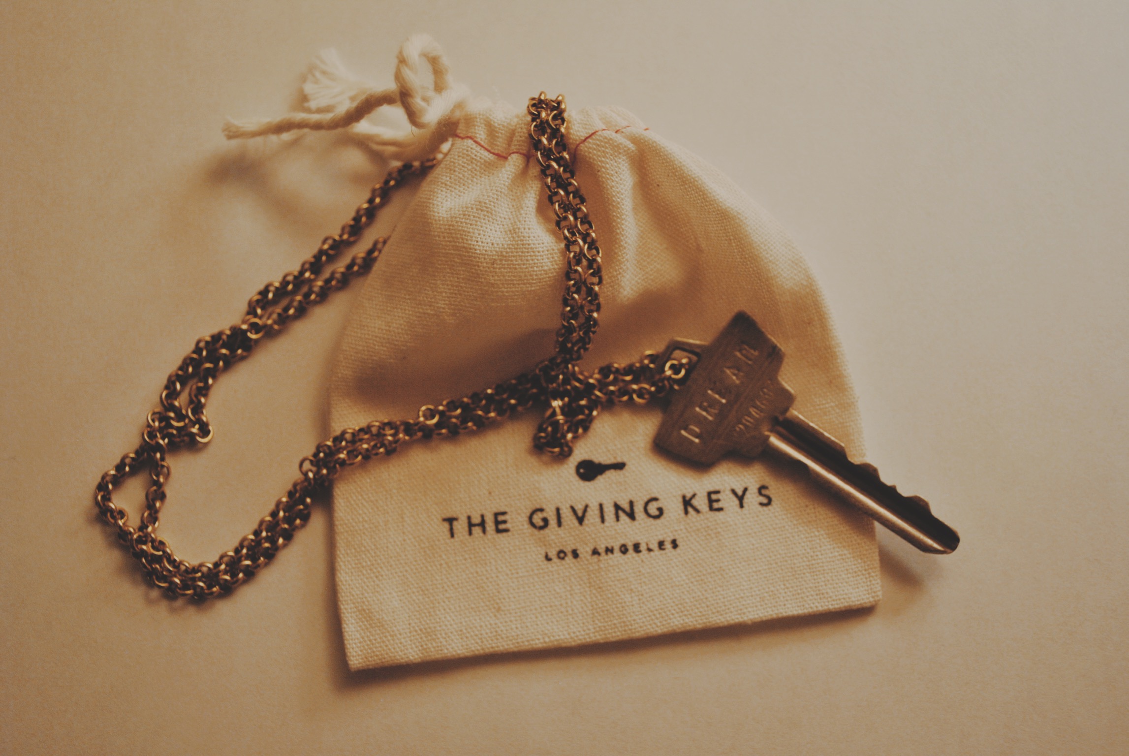 The Giving Key's employs individuals transitioning from homelessness to create inspiring jewellery from repurposed keys. Here is my purchased key with the engraved word Dream.