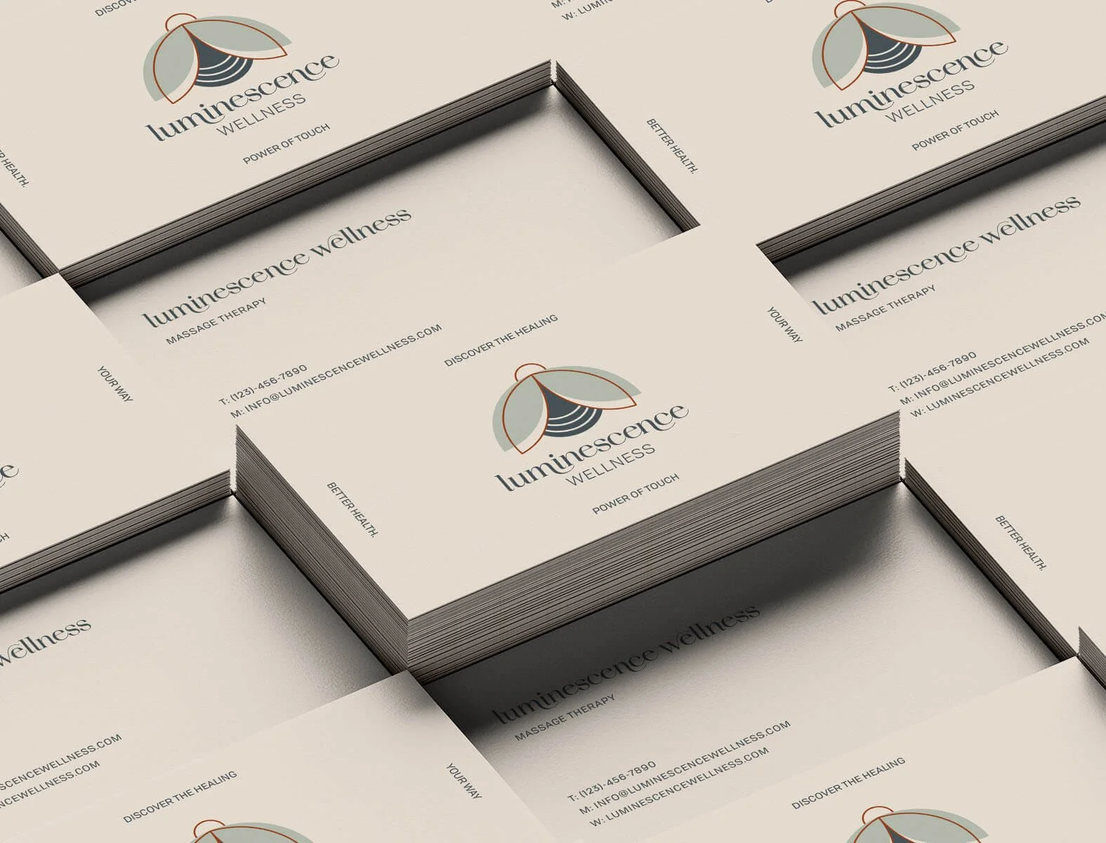 Stack of Luminescence Wellness business cards designed by Laurelle Armet, featuring a minimalist firefly logo, soft neutral tones, and elegant typography for a modern wellness brand identity.