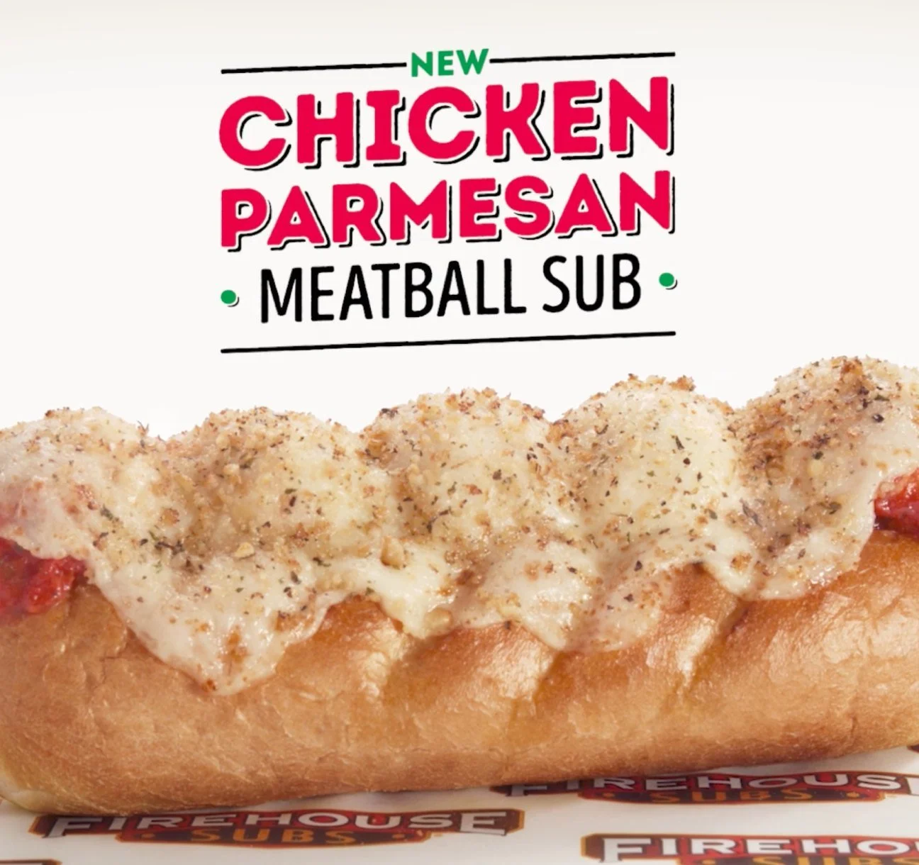 Close-up of a Chicken Parmesan Meatball Sub sandwich in a hot dog bun with melted cheese and seasoning, with 'FIREHOUSE SUBS' branding.