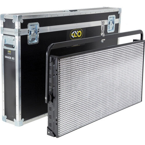 LED stage light panel with black protective frame leaning against a hard case with metal reinforcements and wheels.