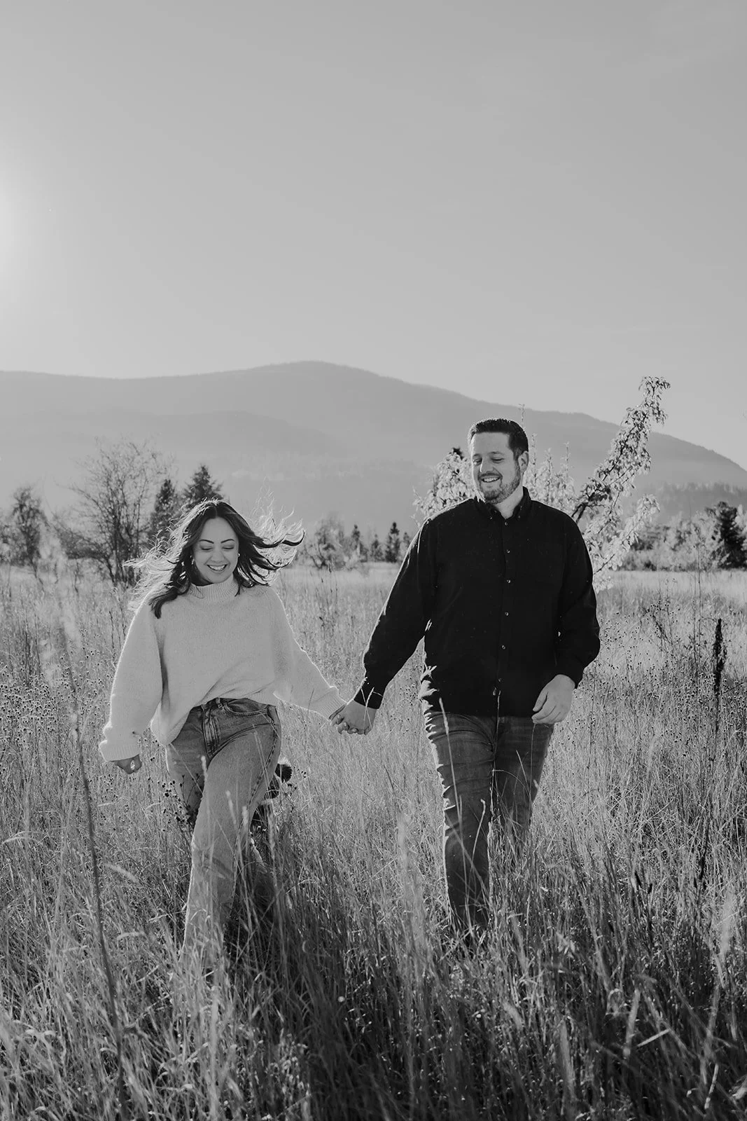 running through the field at sunset in Castlegar BC, the sweetest engagement session with these two