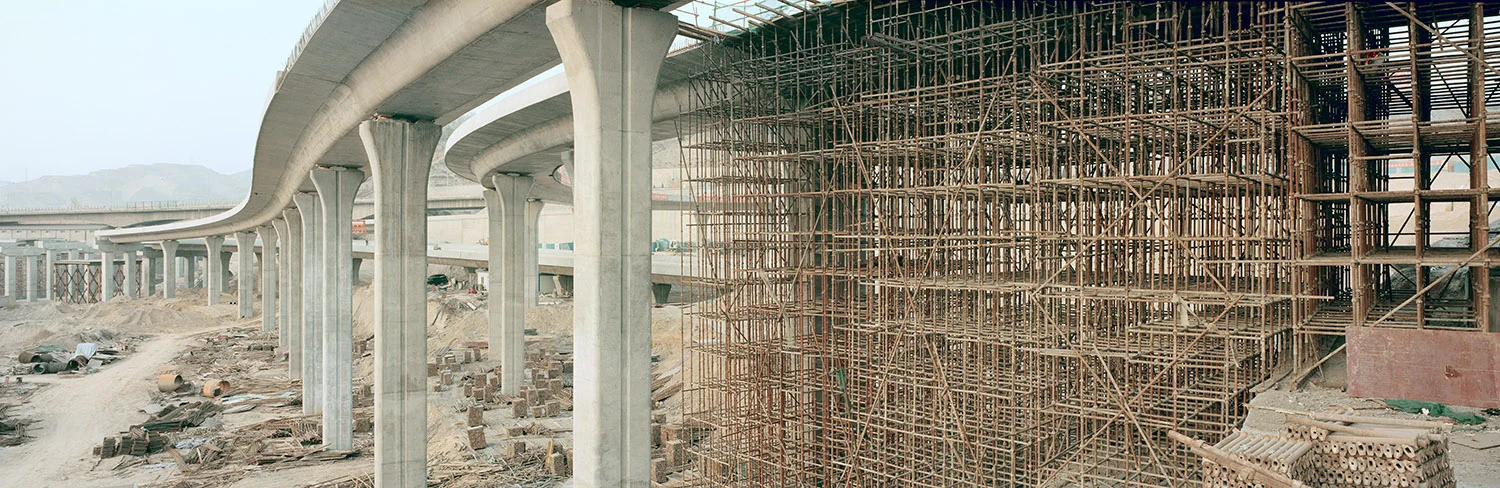 Highway construction. Lanzhou, Gansu, China, 2011. The goal of the “Go West” policy, launched just before China’s entry into the World Trade Organization in 2001, was to develop the economies of China’s western regions. While massive investment has boosted output and effectively raised GDP in the western regions, the project failed to achieve its goal of eliminating the economic gap between eastern and western China. Over $325 billion has been invested in major infrastructure projects in the west, making it one of the biggest economic regeneration programs of all time. 