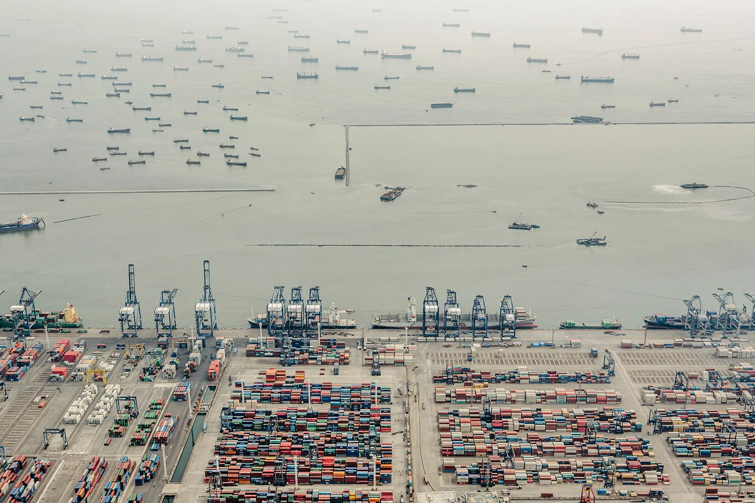 Ships waiting to dock at the the port. The Port of Jakarta also known as Tanjung Priok Port is the largest Indonesian seaport and one of the largest seaports in the Java Sea basin, with an annual traffic capacity of around 45 million tonnes of cargo and 4,000,000 TEU's. This port is located in Tanjung Priok, North Jakarta.