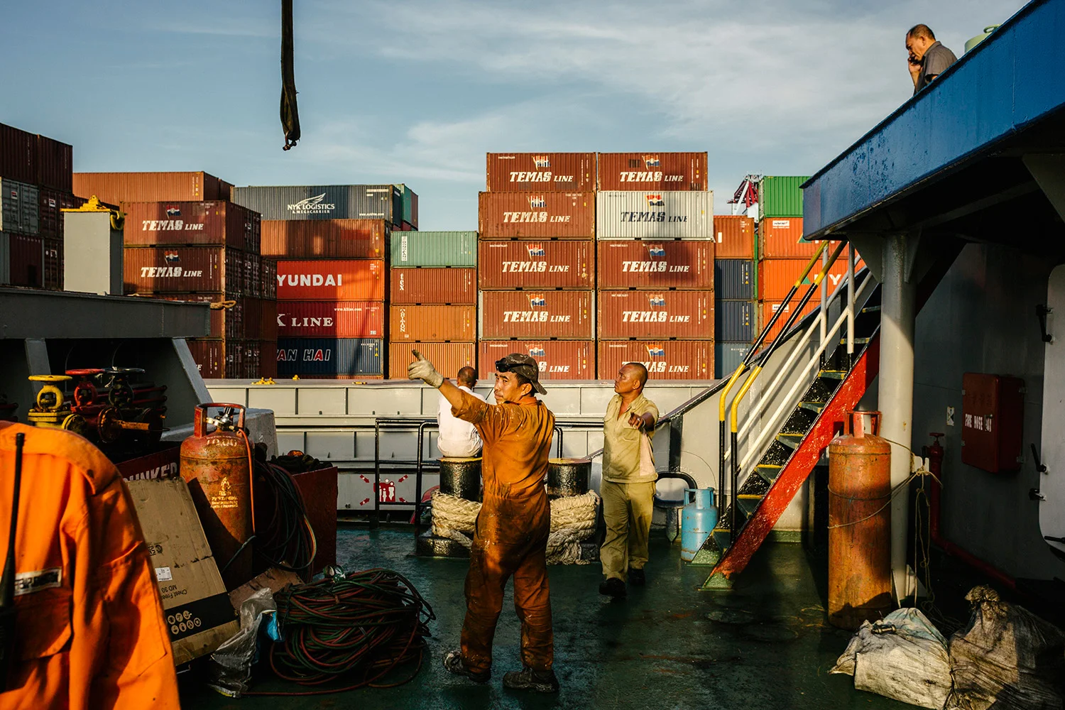 Crew taking a break before having preparing to load the ship with cargo. The Port of Jakarta also known as Tanjung Priok Port is the largest Indonesian seaport and one of the largest seaports in the Java Sea basin, with an annual traffic capacity of around 45 million tonnes of cargo and 4,000,000 TEU's. This port is located in Tanjung Priok, North Jakarta.