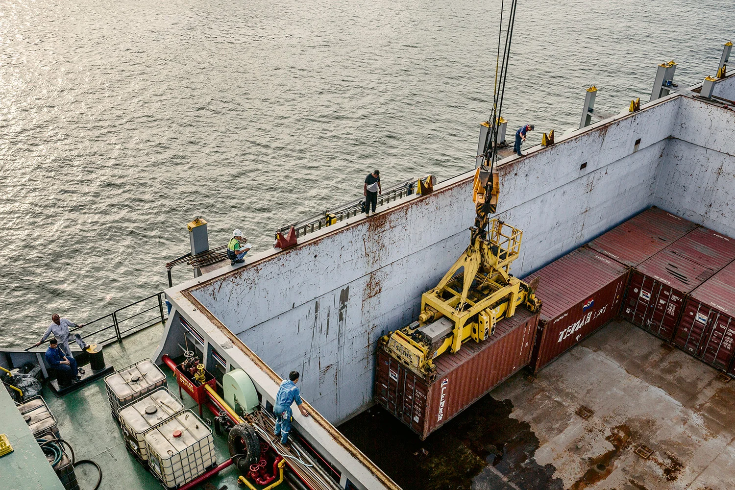 Crew working to get containers onto the ship by crane. The Port of Jakarta also known as Tanjung Priok Port is the largest Indonesian seaport and one of the largest seaports in the Java Sea basin, with an annual traffic capacity of around 45 million tonnes of cargo and 4,000,000 TEU's. This port is located in Tanjung Priok, North Jakarta.