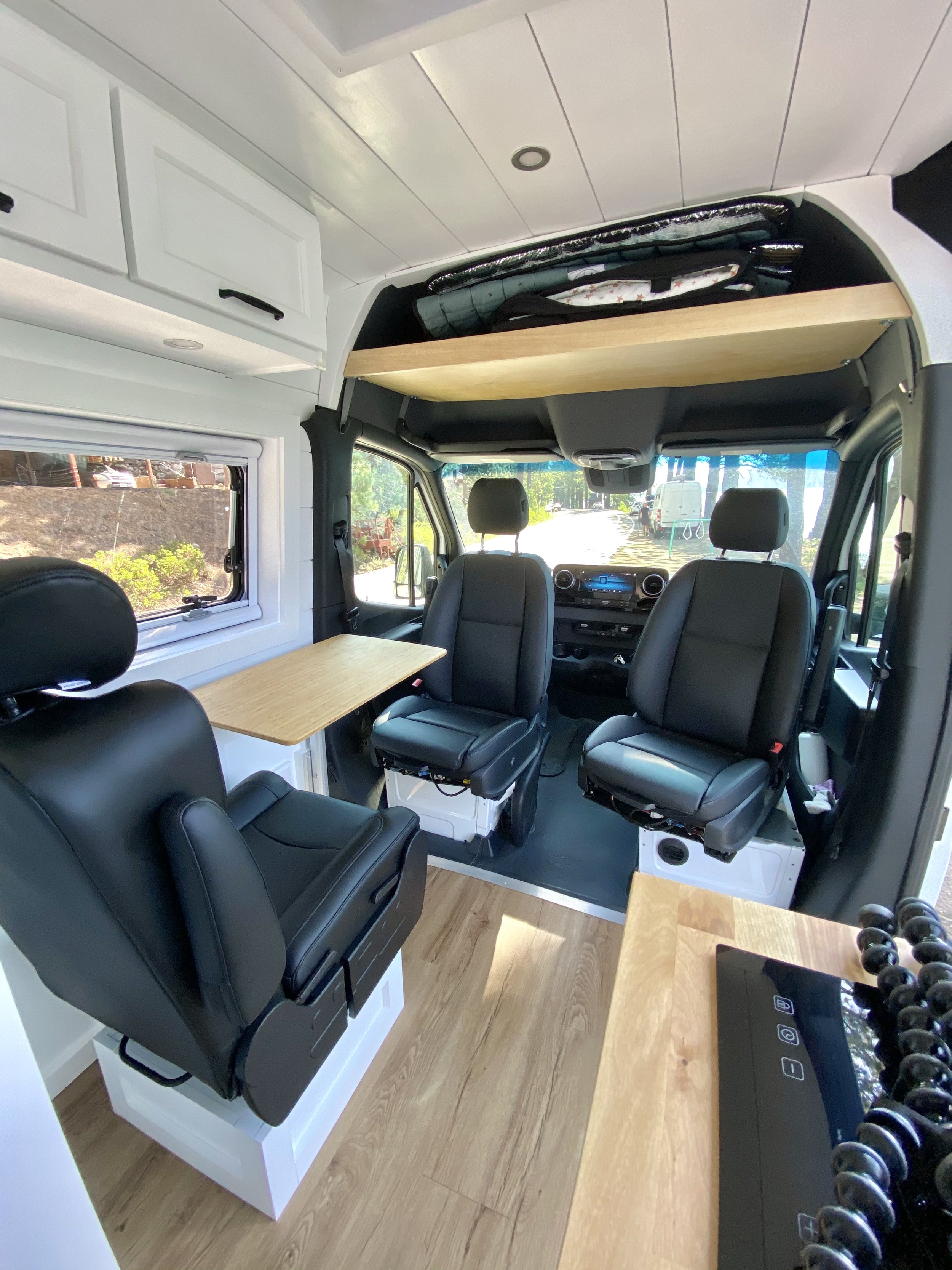 Custom Crafted Luxury Van Conversion for Family of 3 front seating area.jpg