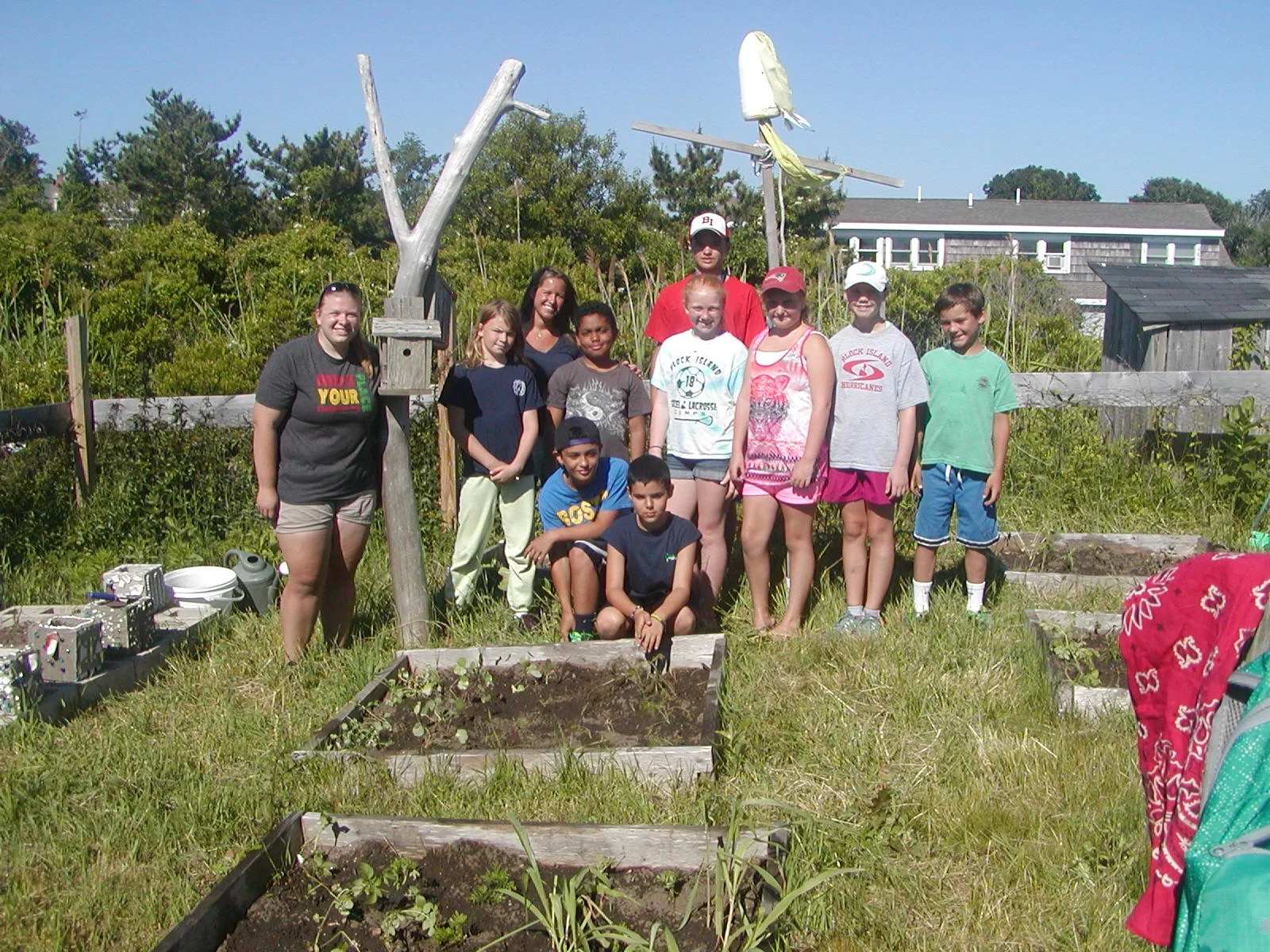The BI 4th graders posing for a group photo in their garden.