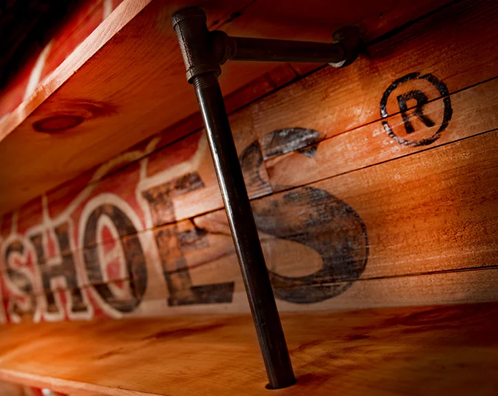   Steel pipe shelving with a hand-painted wood wall.  