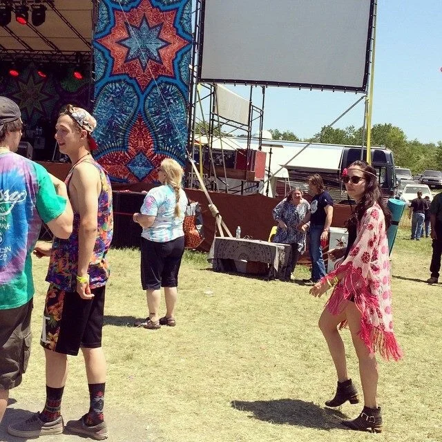 Walking the Strange Creek festival last year wearing a Free People fringe kimono, Aldo studded ankle booties, and Express cutoff black denim shorts and H&M black crop top.Β
