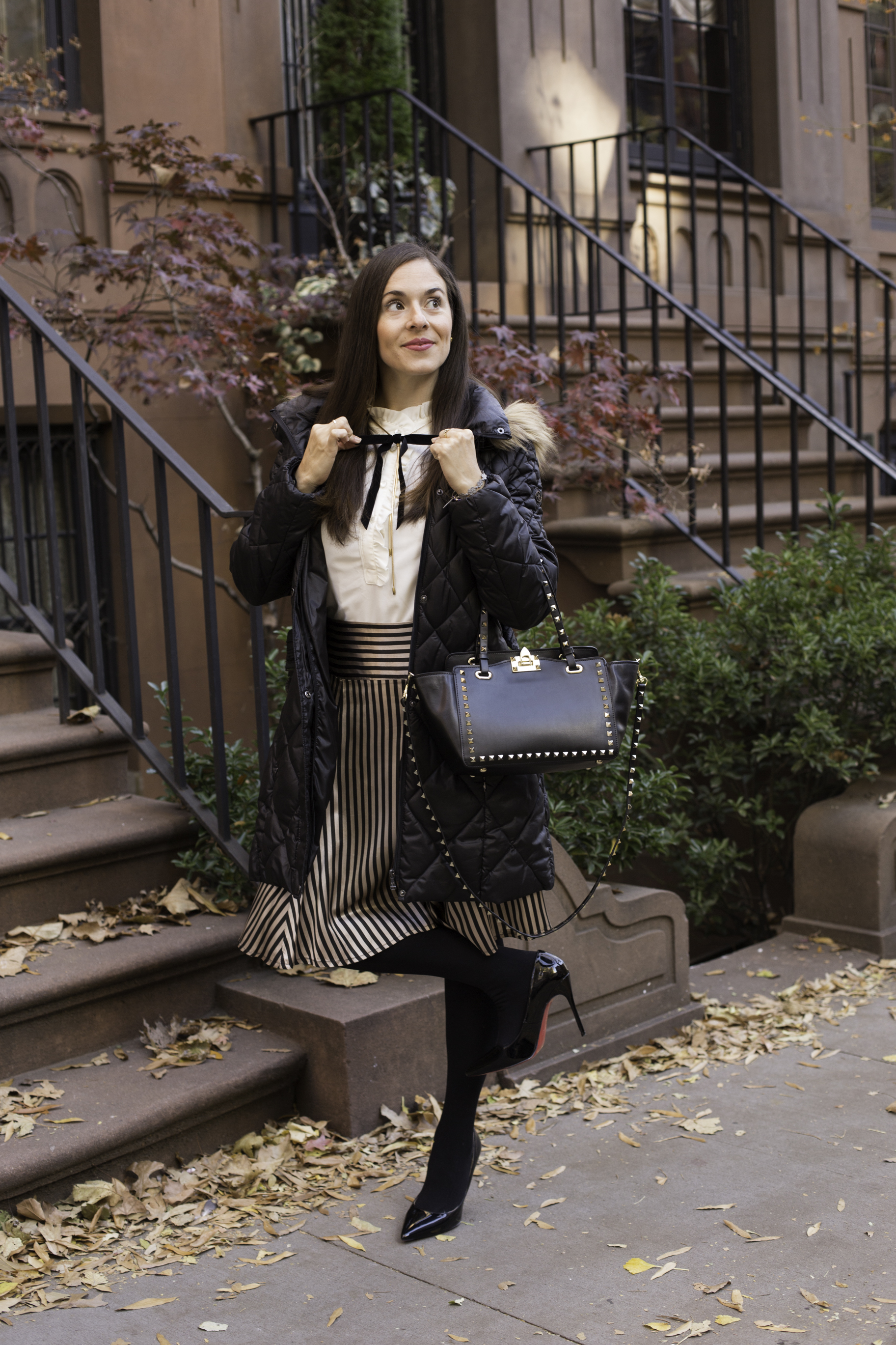 In my JCrew sleeveless ruffled collar top with Free People gold chain and attached velvet black bow, vintage striped skirt, black tights and Christian Louboutin pumps, Valentino Rock Stud bag and Guess coat. Photography by Francisco Graciano .