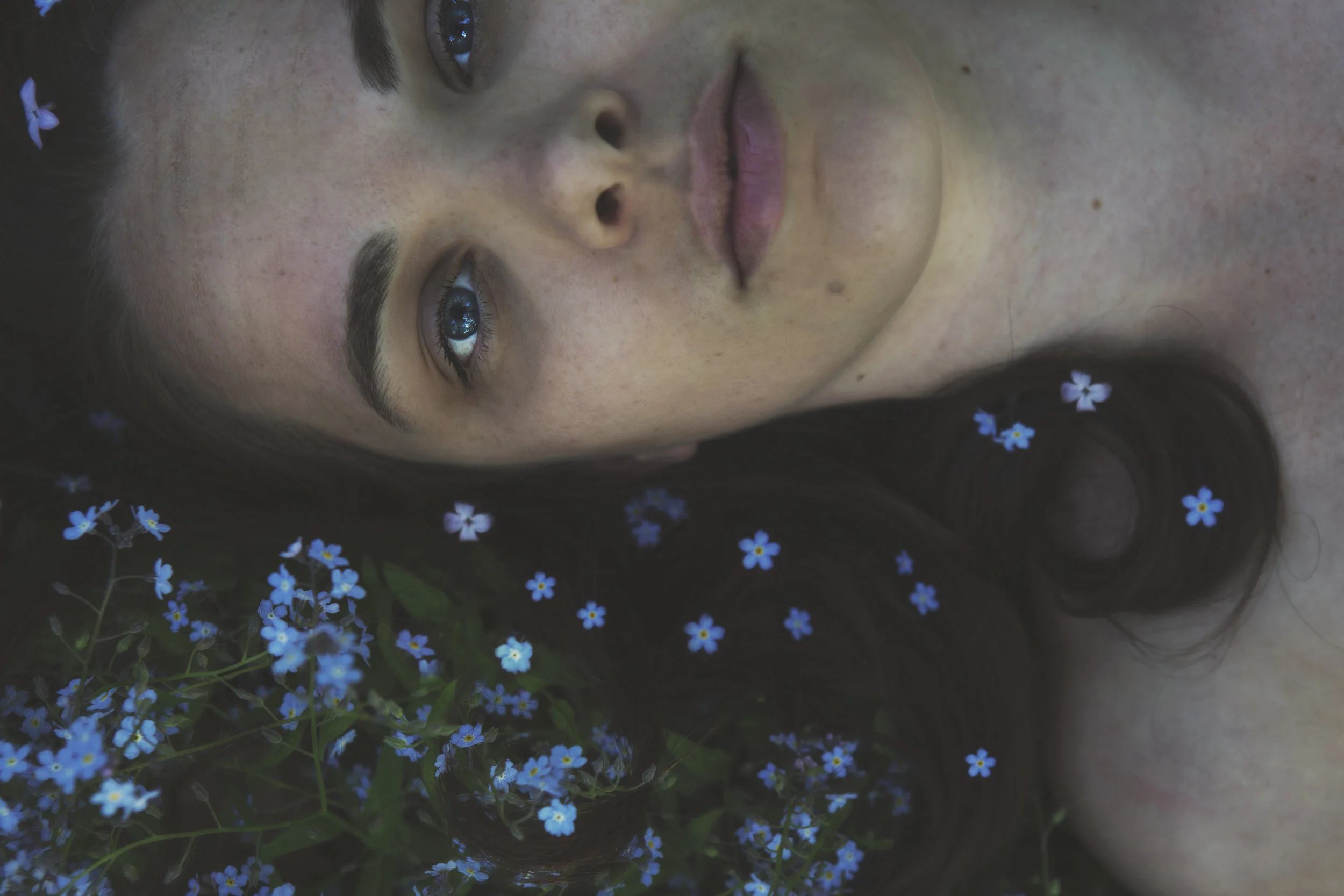 A girl in a bed of flowers