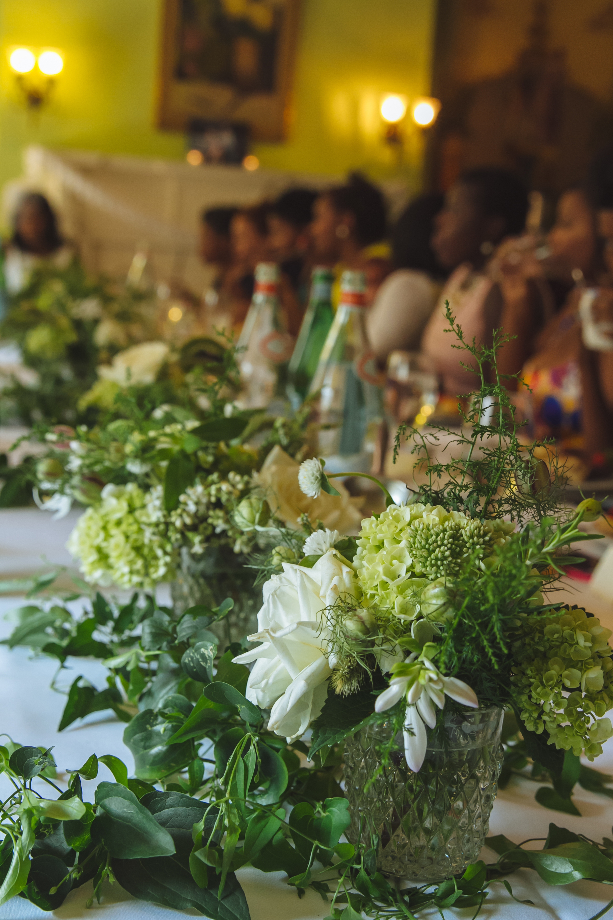 The client wanted a single long table for her tea party with lush white and green flowers to adorn the table. 
