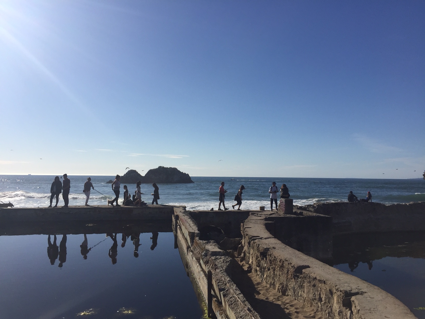 Visitors walking the Sutro Bath ruins