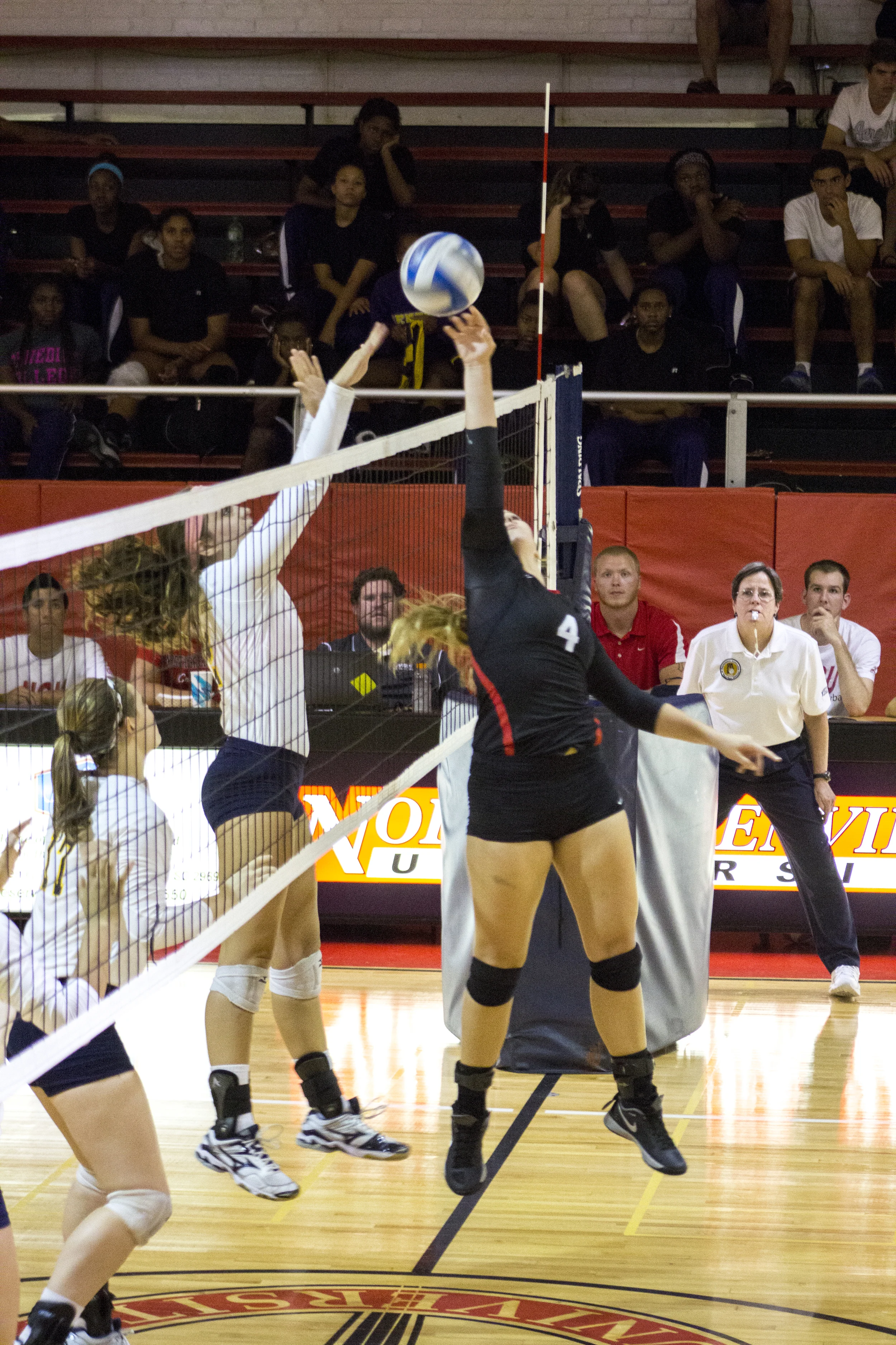 Sophomore Ashlyn Wilkinson tips the ball over to the opponent's side of the court. 