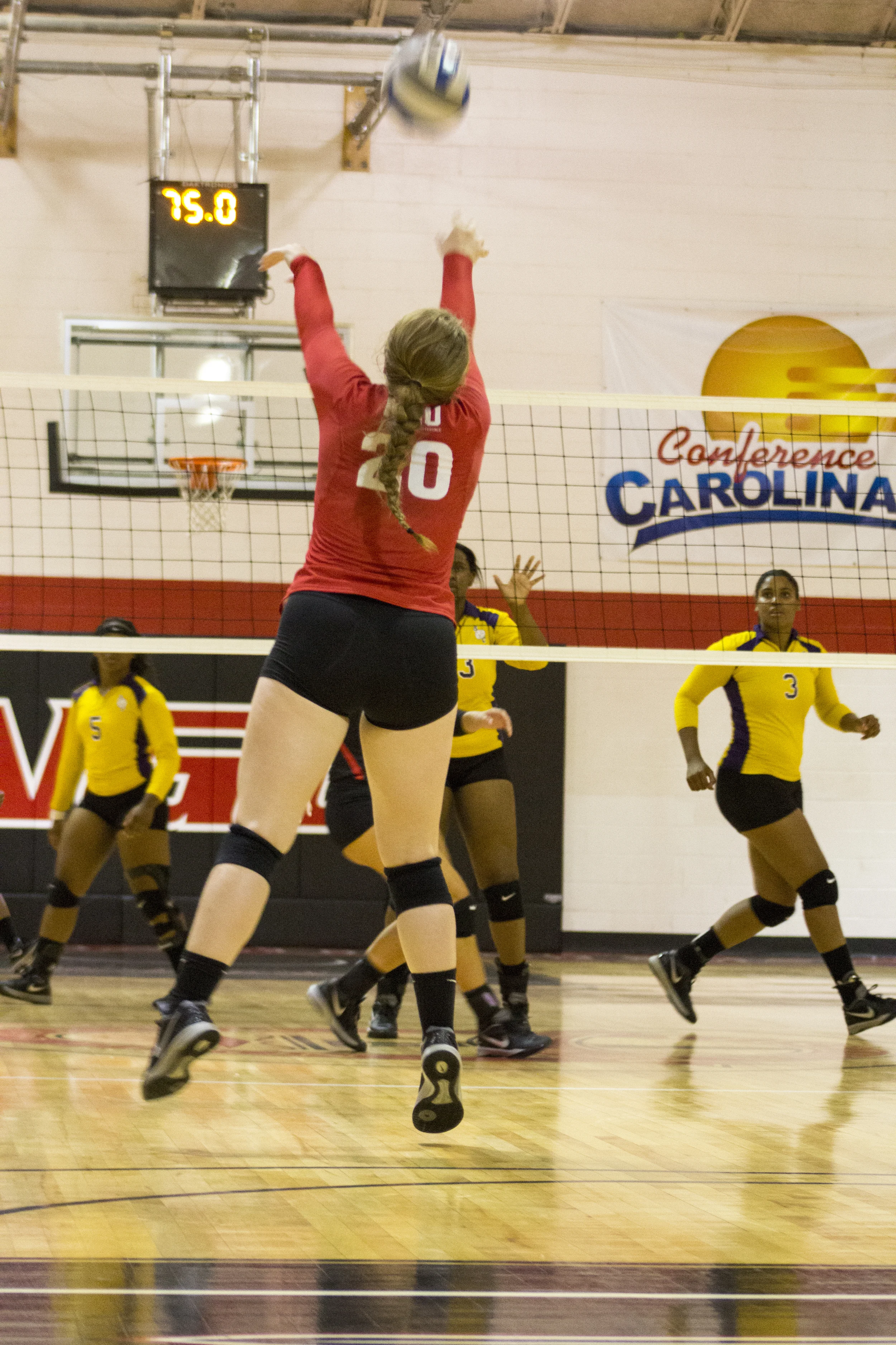 Junior Hannah Lewis jumps up to forward set the ball for her teammates. 