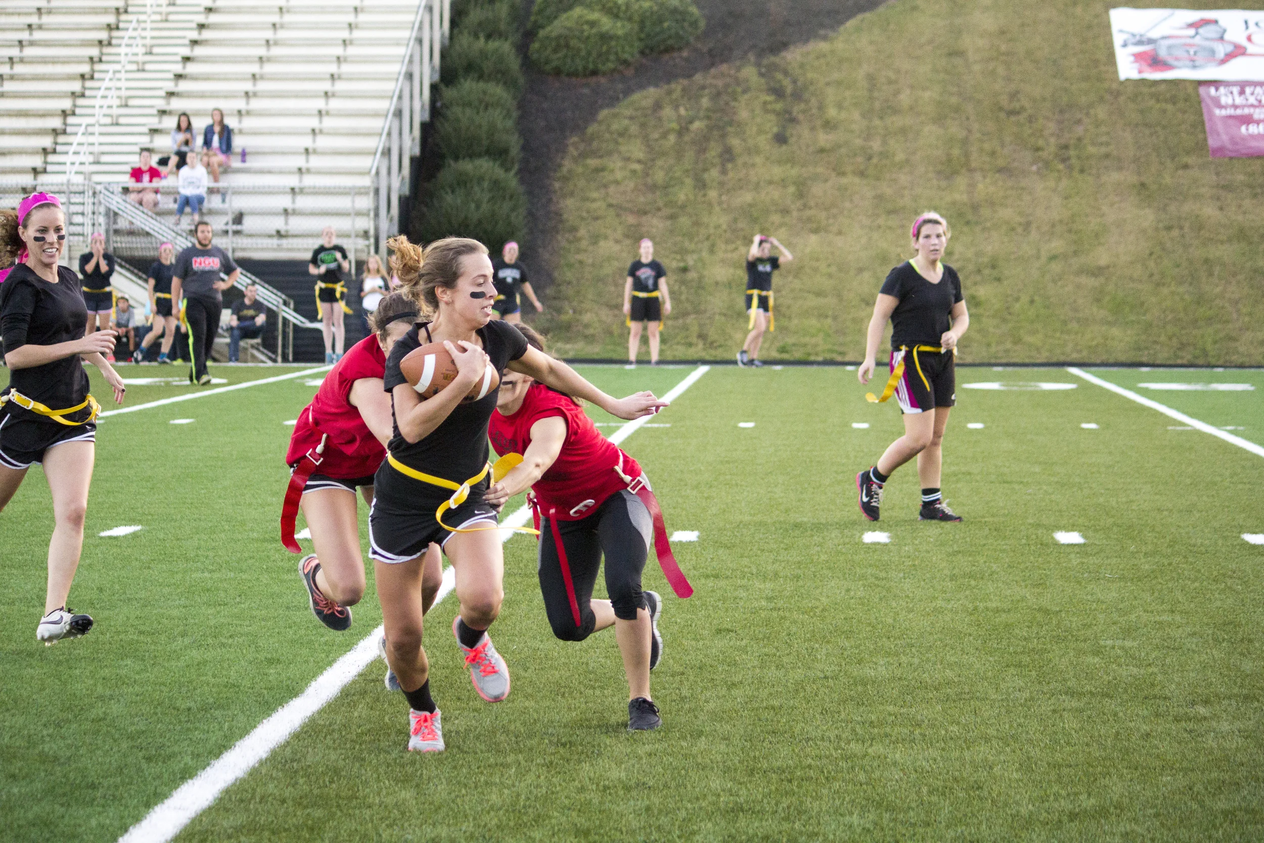 Junior Kacey Beck barely makes it past two junior players stretched out to grab her flag.