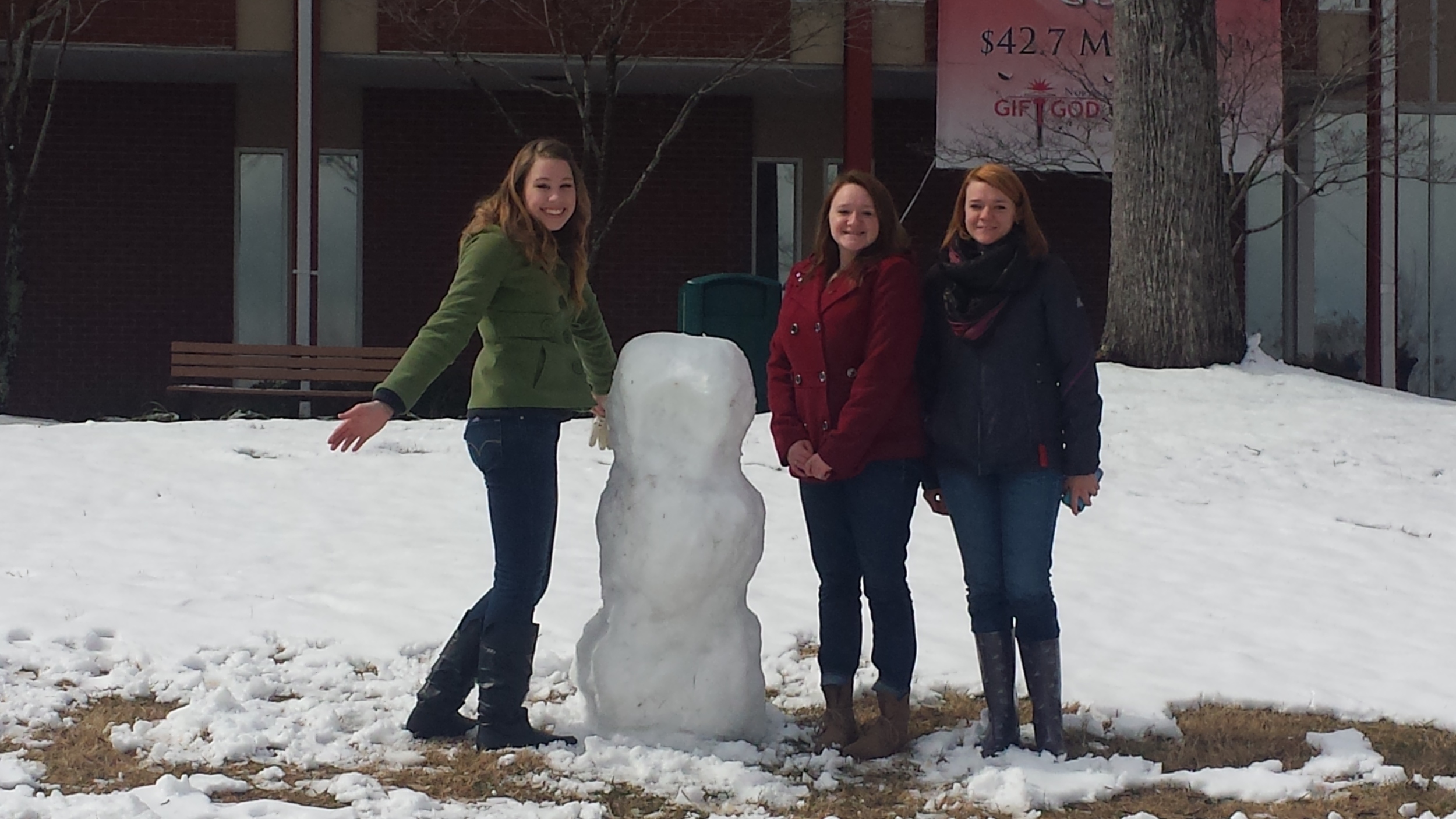 Students Rebekah Kington, Sabrina Cook and Samantha Cook build a snowman Thursday morning. Photo by Megan Conley