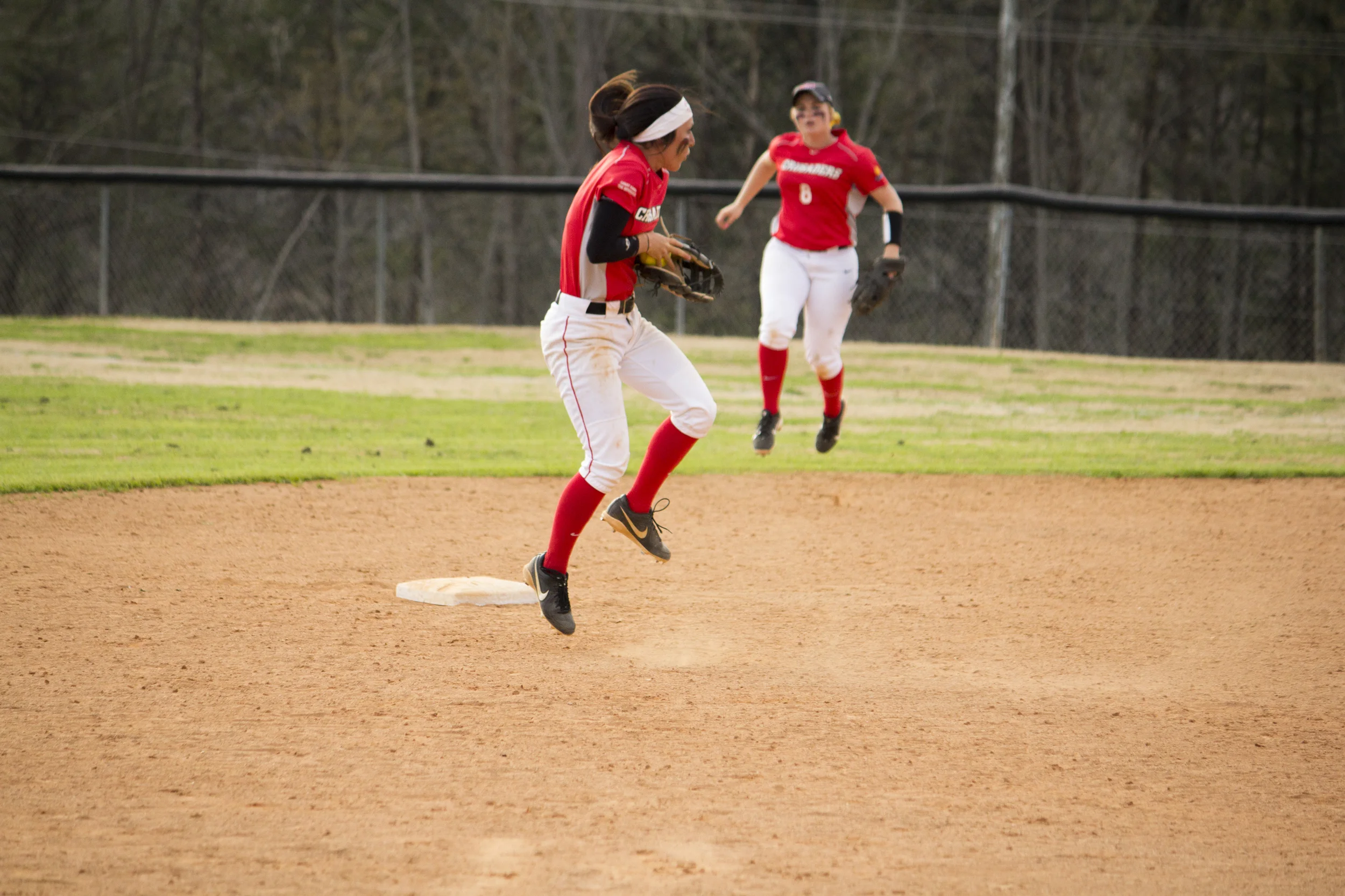 Sophomore Shayna Finley jumps up to stop the ball and throw it to first base. 
