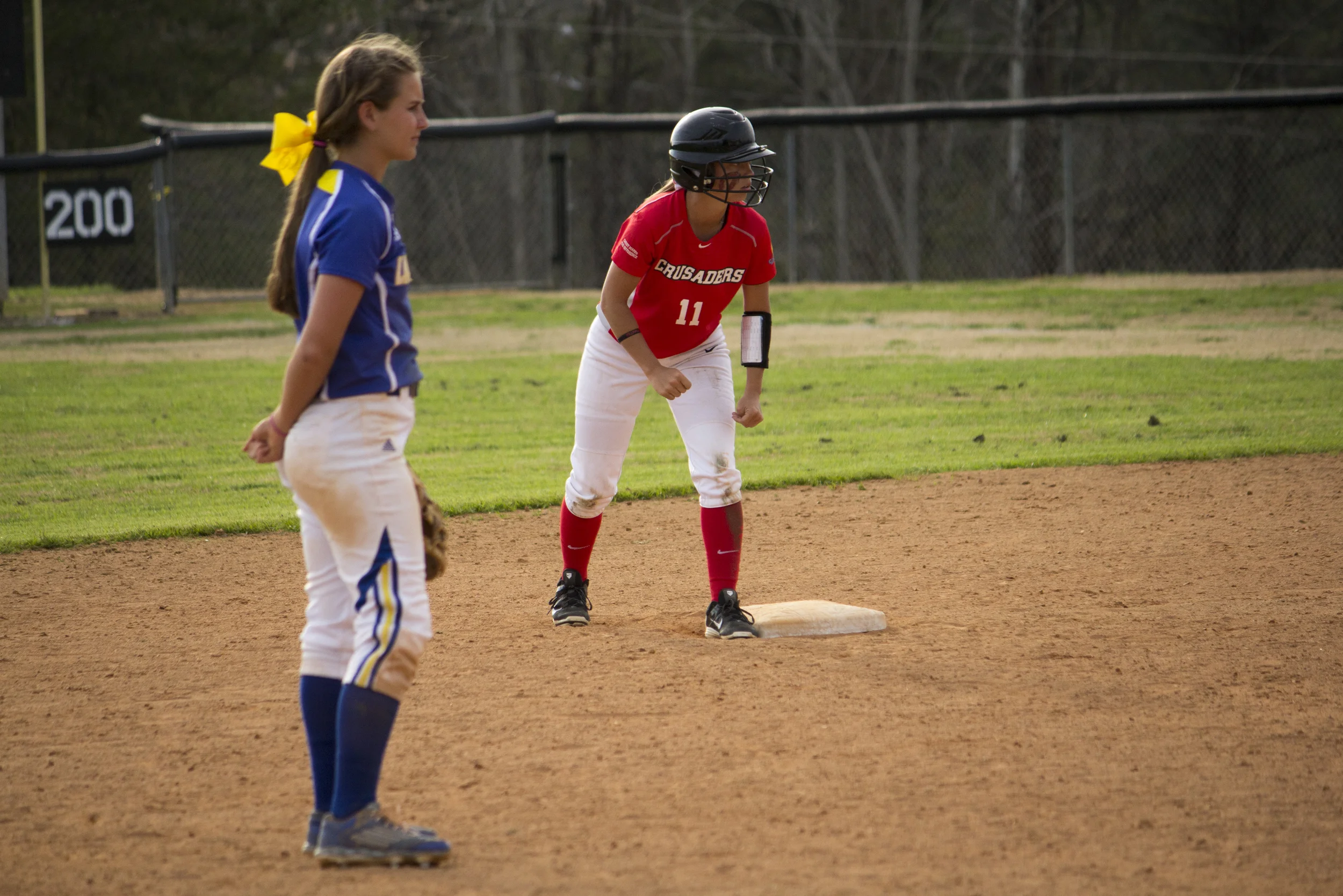 Freshman Tracy Howell anticipates her batting teammate's hit. 