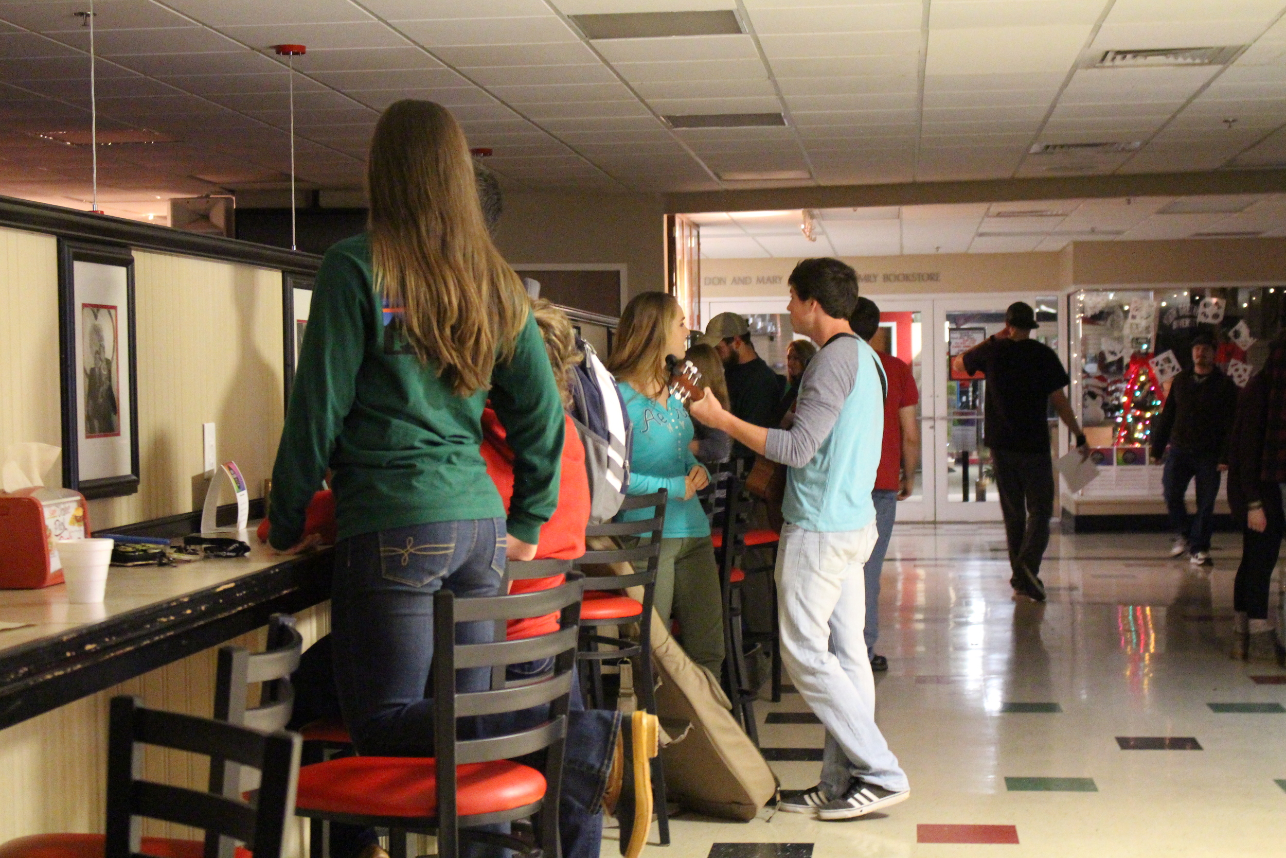 Students preparing to perform and rehearsing for the coffeehouse