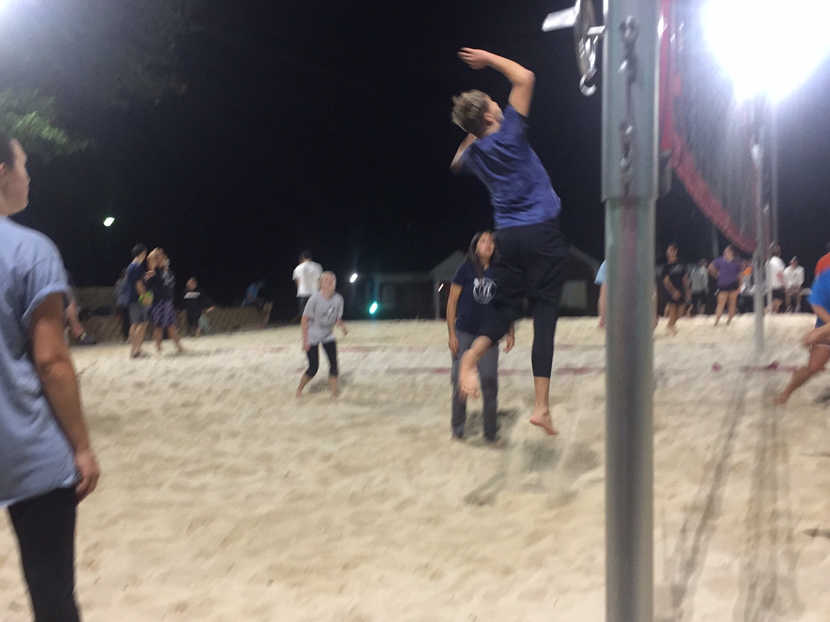 Connor Hash in mid air spikes the ball over the net to add points to the board. Photo By: Grant Moses