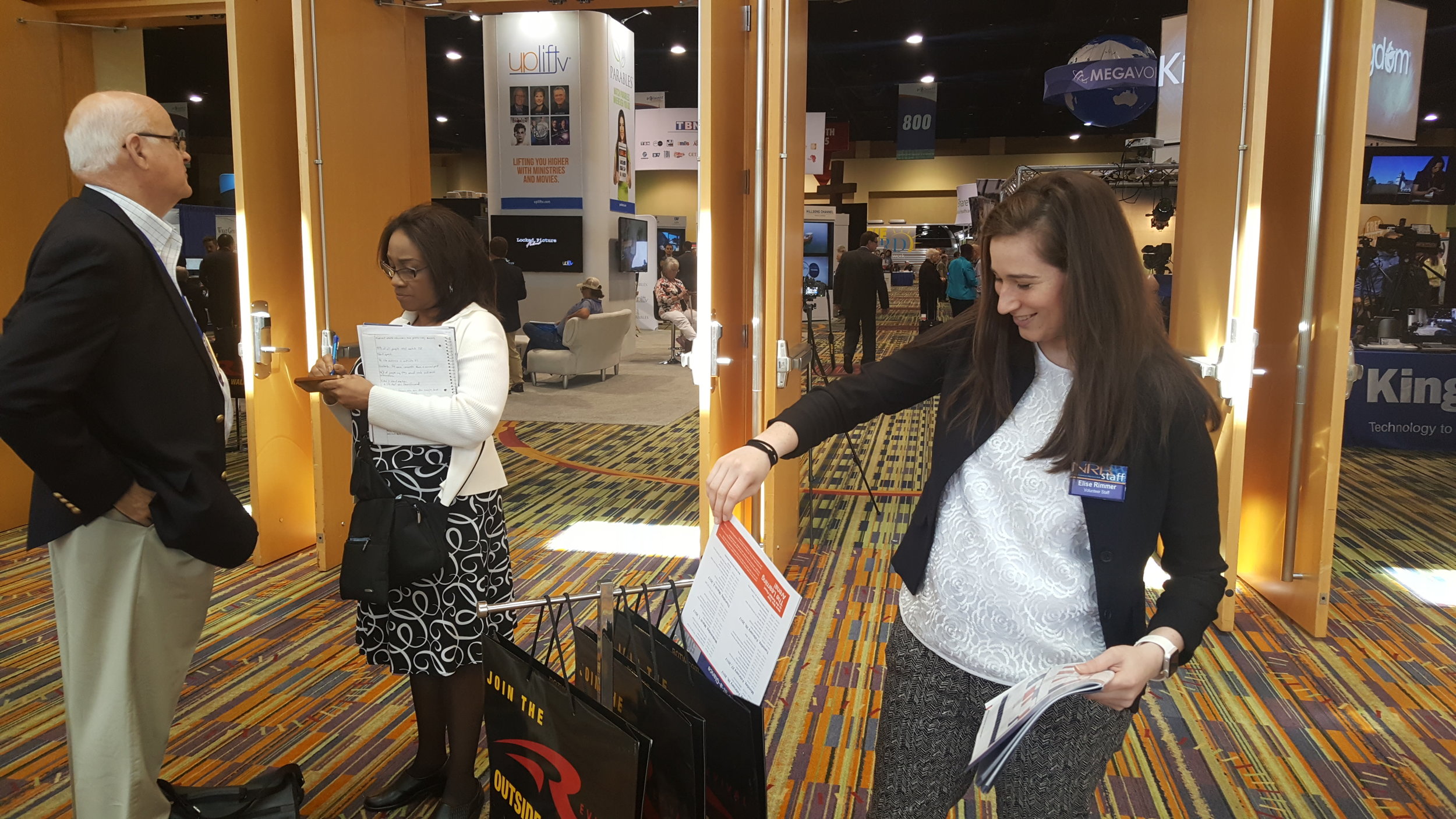 Elise Rimmer helps out with facilities in front of the expo by filling bags with pamphlets. 
