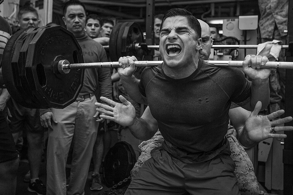 Jace Manning, Marine Medium Tiltrotor Squadron (VMM) 263 (Reinforced), 22nd Marine Expeditionary Unit (MEU), air traffic control staff noncommissioned officer in charge and native of Belton, Texas, squats 385 pounds during a weight-lifting competition aboard the USS Bataan (LHD 5), at sea, April 20, 2014. Photo courtesy of Wikimedia Commons.