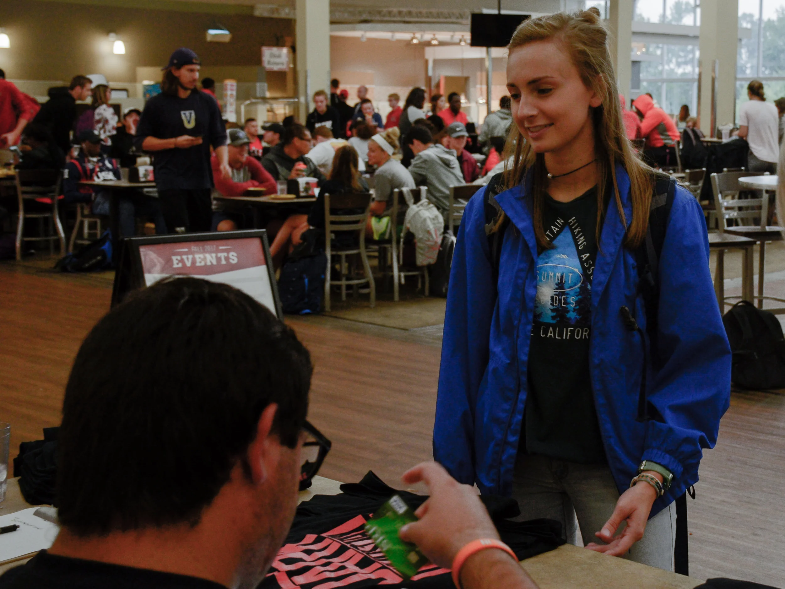 Sophomore Sarah Bishop supports the NGU football team during lunch Thursday (August 31) afternoon as she buys a "Dark Thursday" T-shirt in the cafeteria before the first game of the season.
