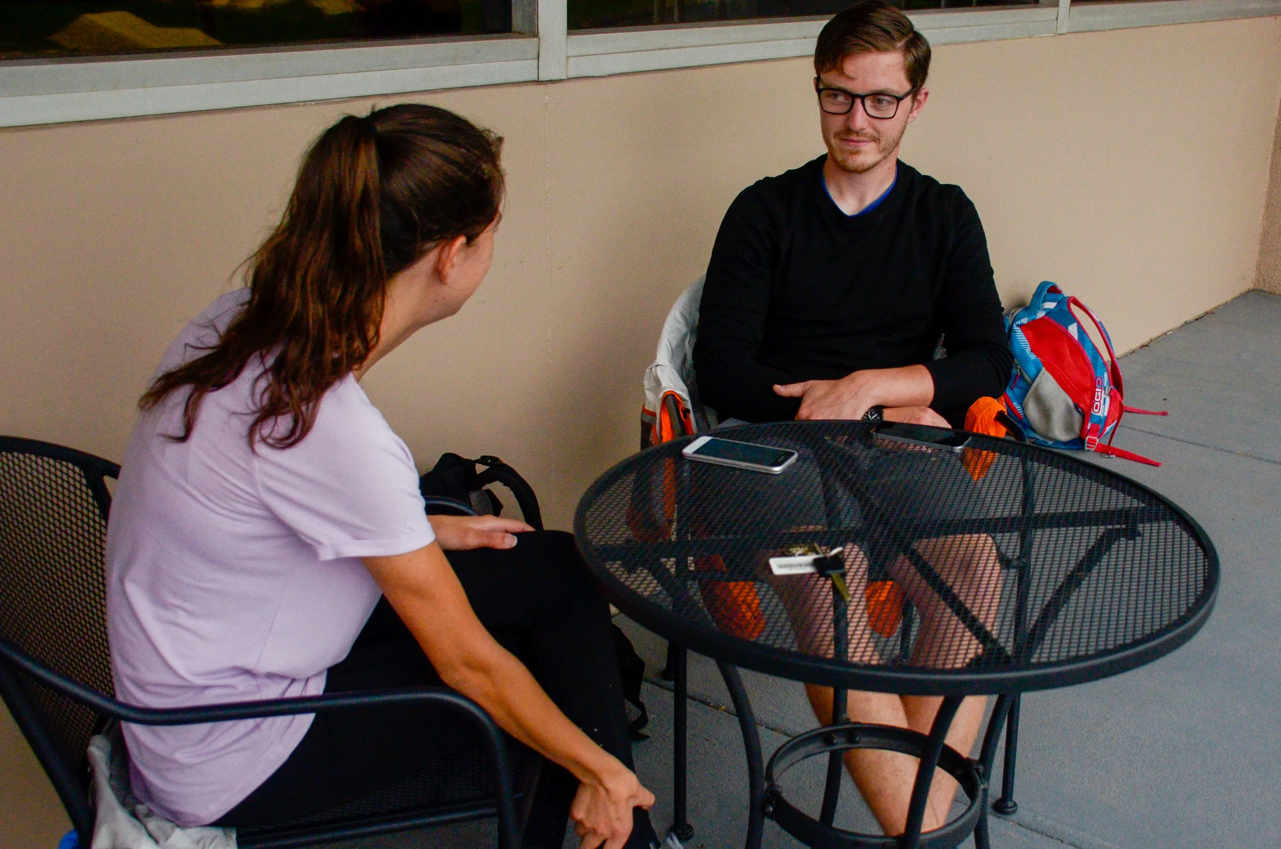 Ty Gautier, senior, catches up with his friend, Erin Leggett, as they relax and chat outside of the library.