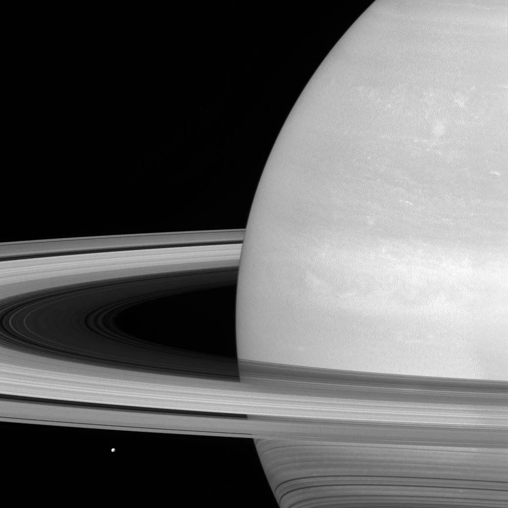 6. “Tiny Mimas” Mima, characterized by its covering in ice, rests beneath Saturn’s rings.