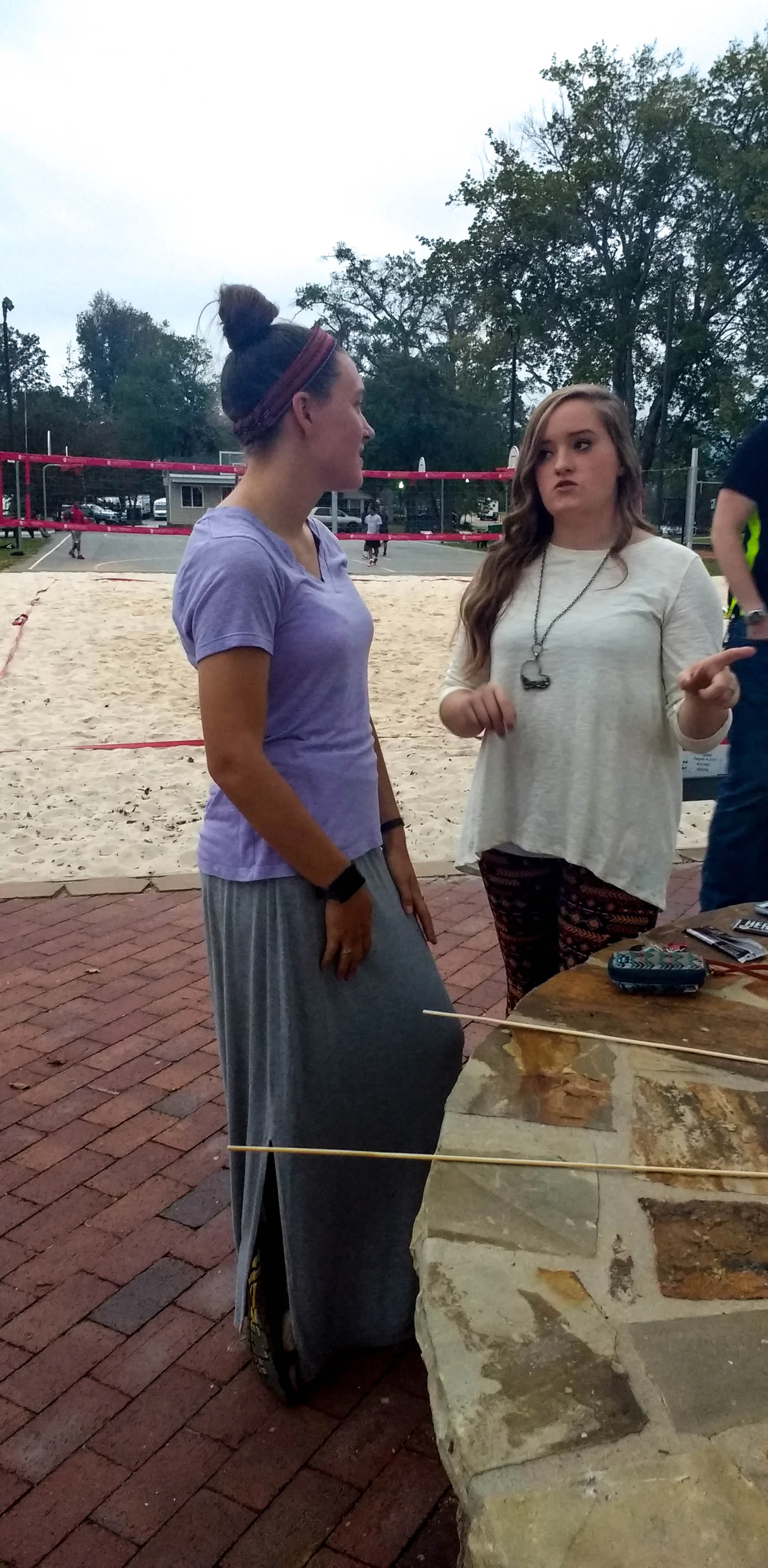 Rebecca Komoroski (Senior) and Christine Adcock (Senior) talking over s'mores.
