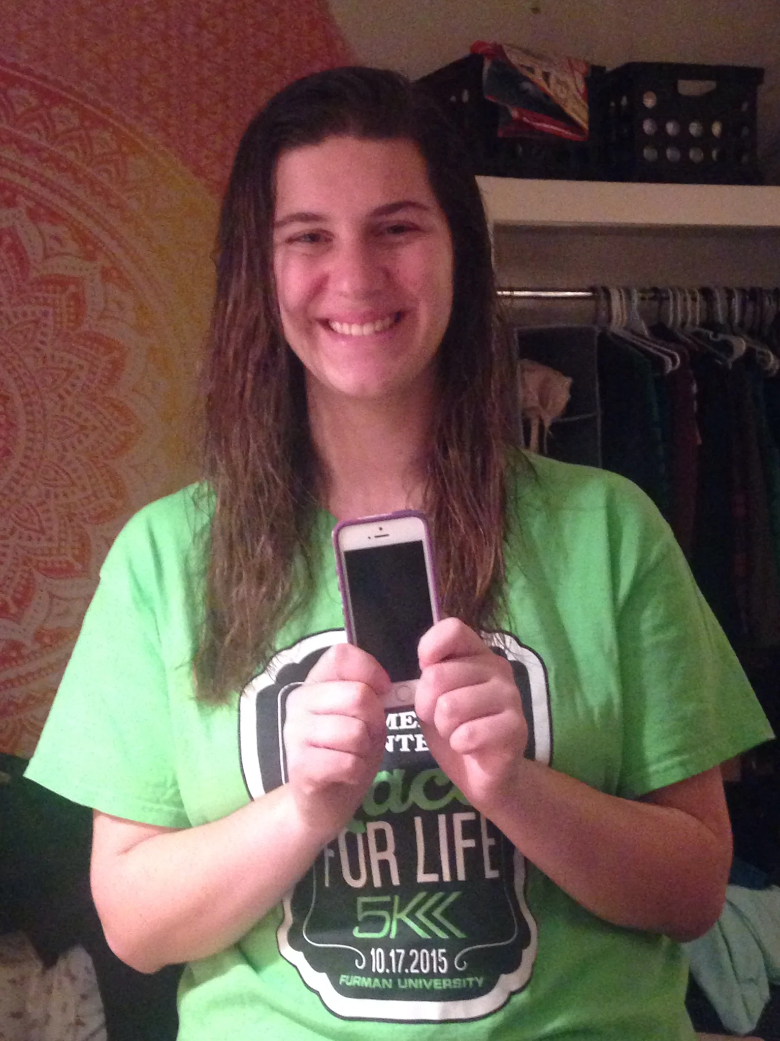 Sara Williams (Sophomore - Secondary English Language Arts Education) is posing with her favorite gift, her phone given by her dad. 