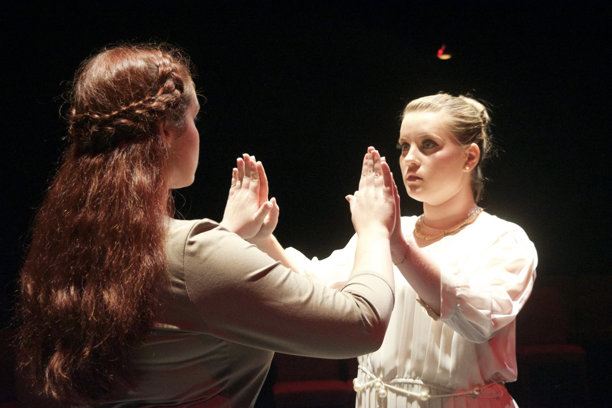 Junior, Ashlynn Butrovich and sophomore, Marlee Daniel intensely perform as Antigone and Ismene. Picture courtesy of NGU Theatre Facebook page