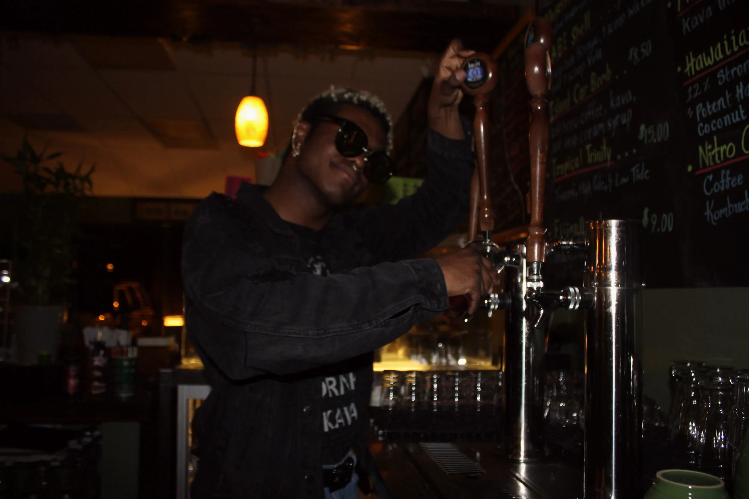 Above is Kava employee, Marcus Rivers, showing how to pour Kombucha out of tap. This drink has many health benefits and tastes great too.