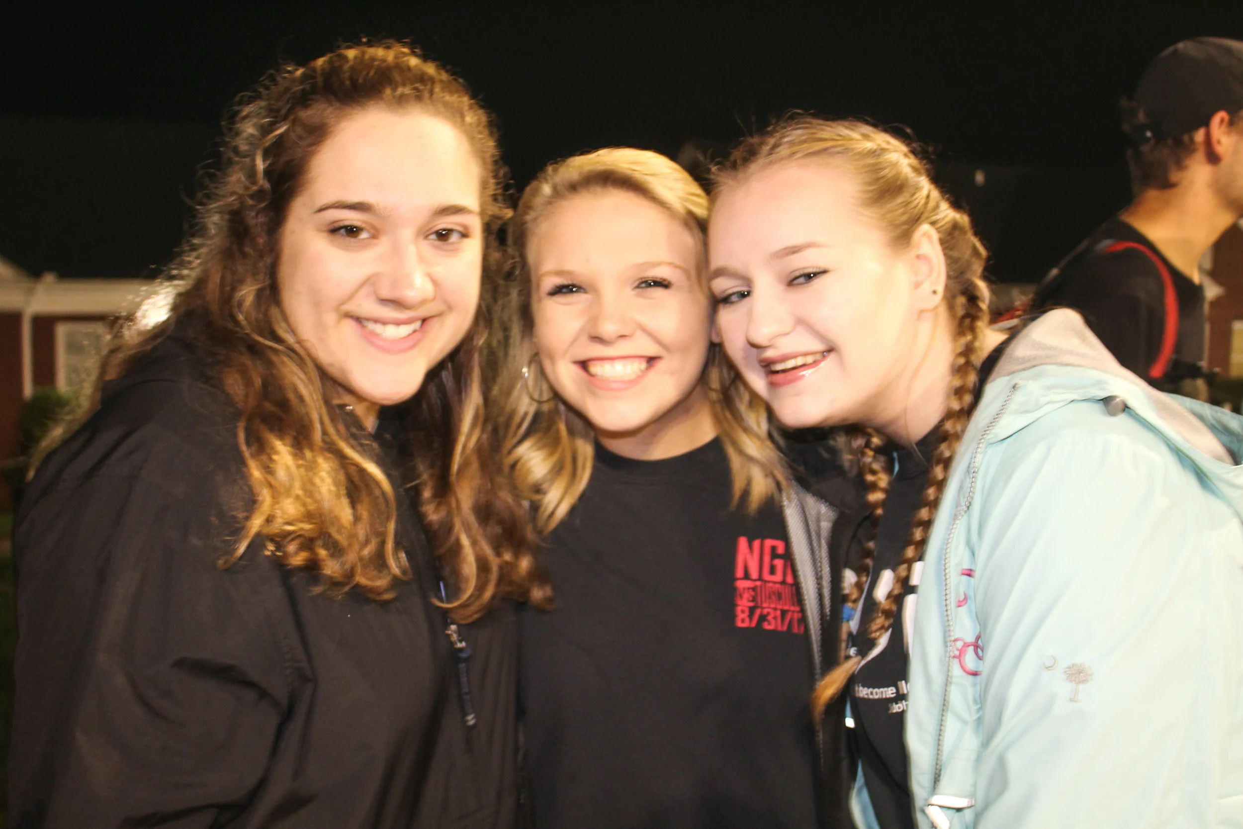 Sophomore BCM members Nicole Pollard, Mary Collins and Kelsey Truluck show their support for the BCM volleyball team as the watch them play.