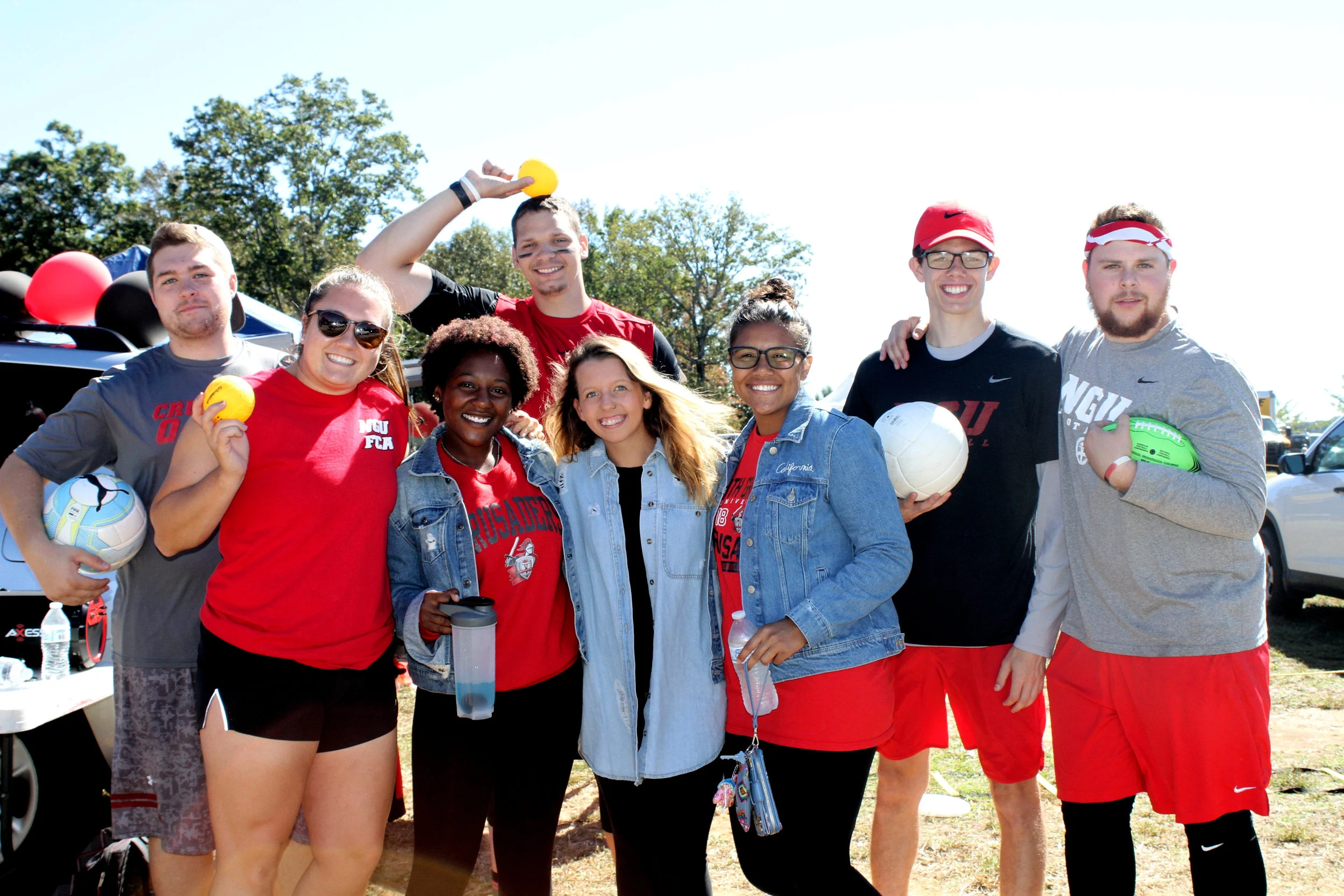 FCA stands on the sidelines of the parade as they cheer on their homecoming representative and play a few games they have for people to enjoy.